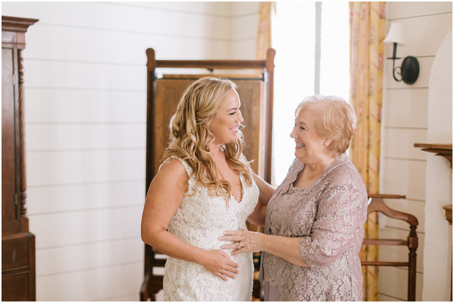 mom and bride laugh while getting ready for North Carolina wedding day