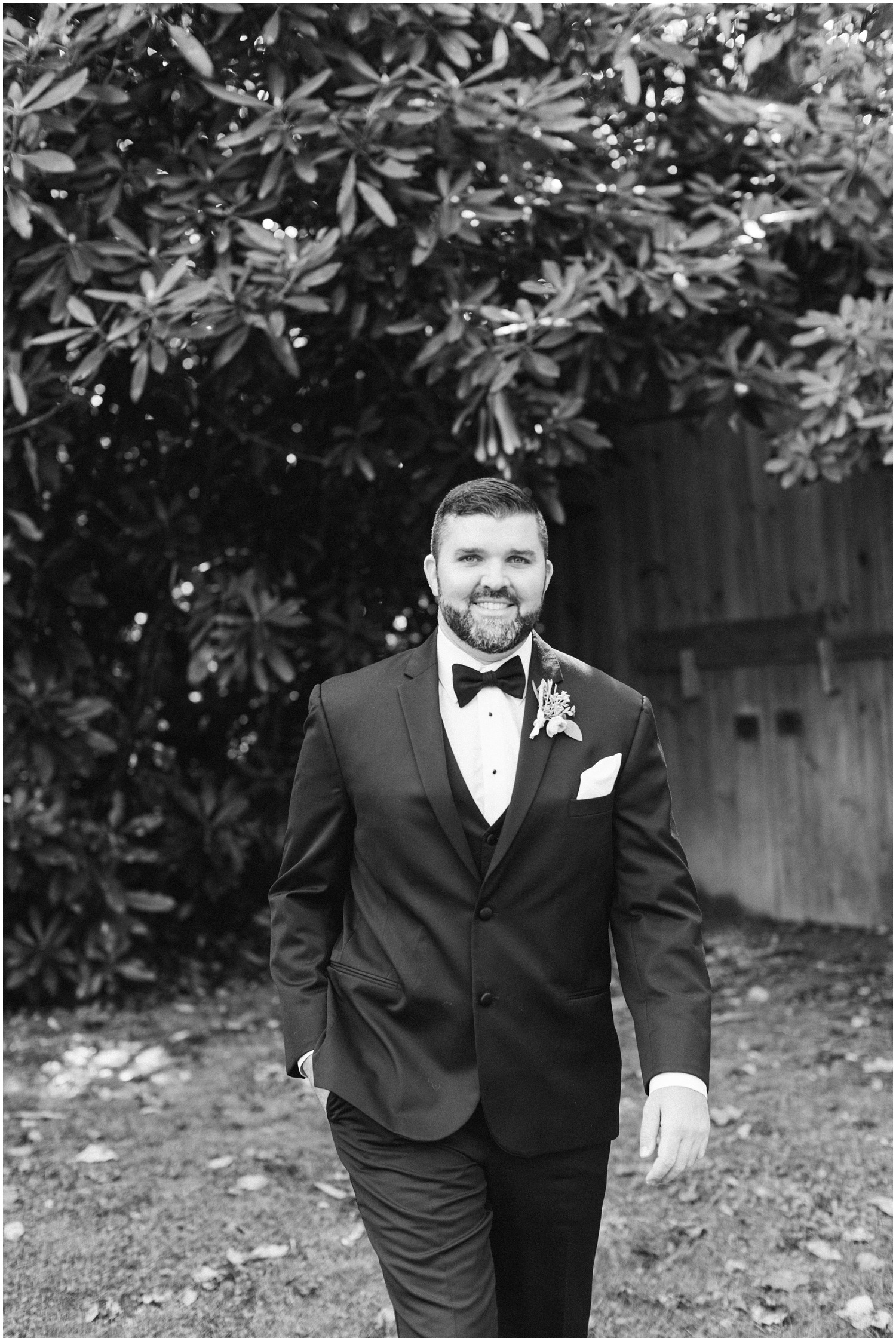 black and white portrait of groom in tux on wedding day