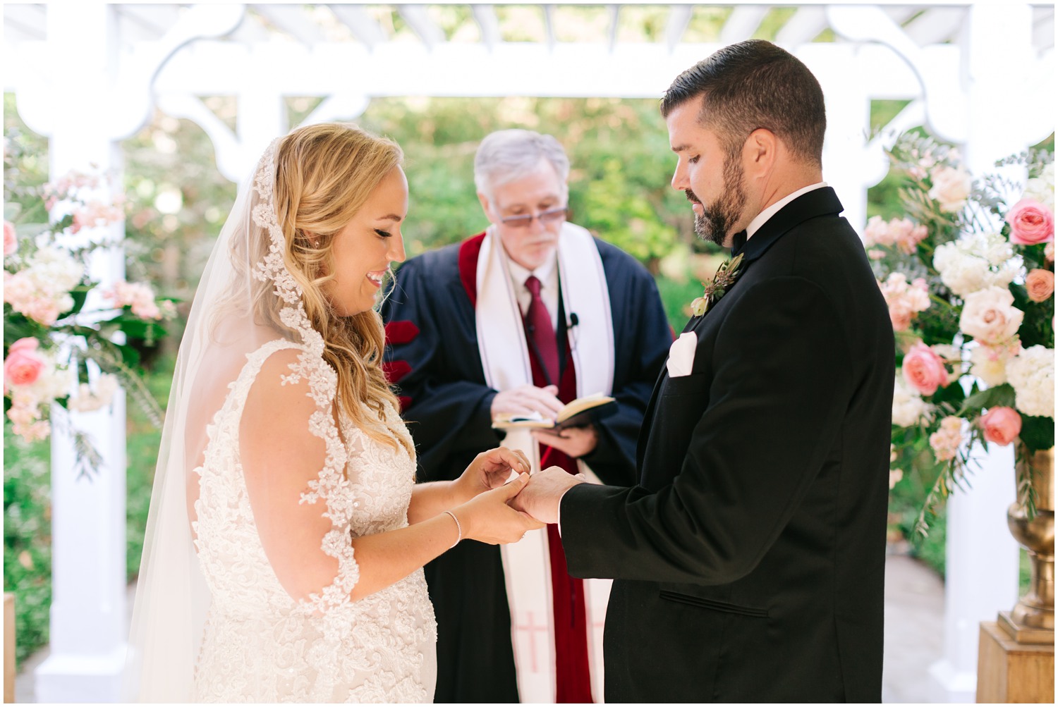 bride puts ring on groom's finger during wedding ceremony in Highlands NC