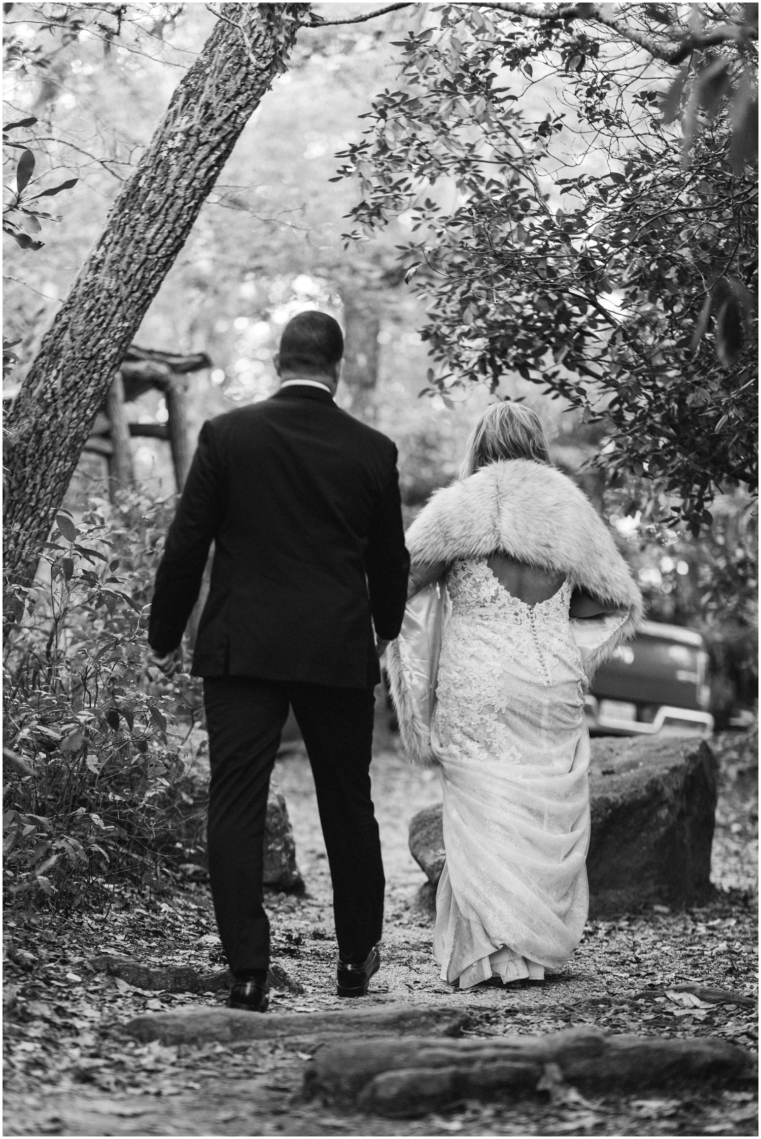 bride and groom walk down hill at Old Edwards Inn