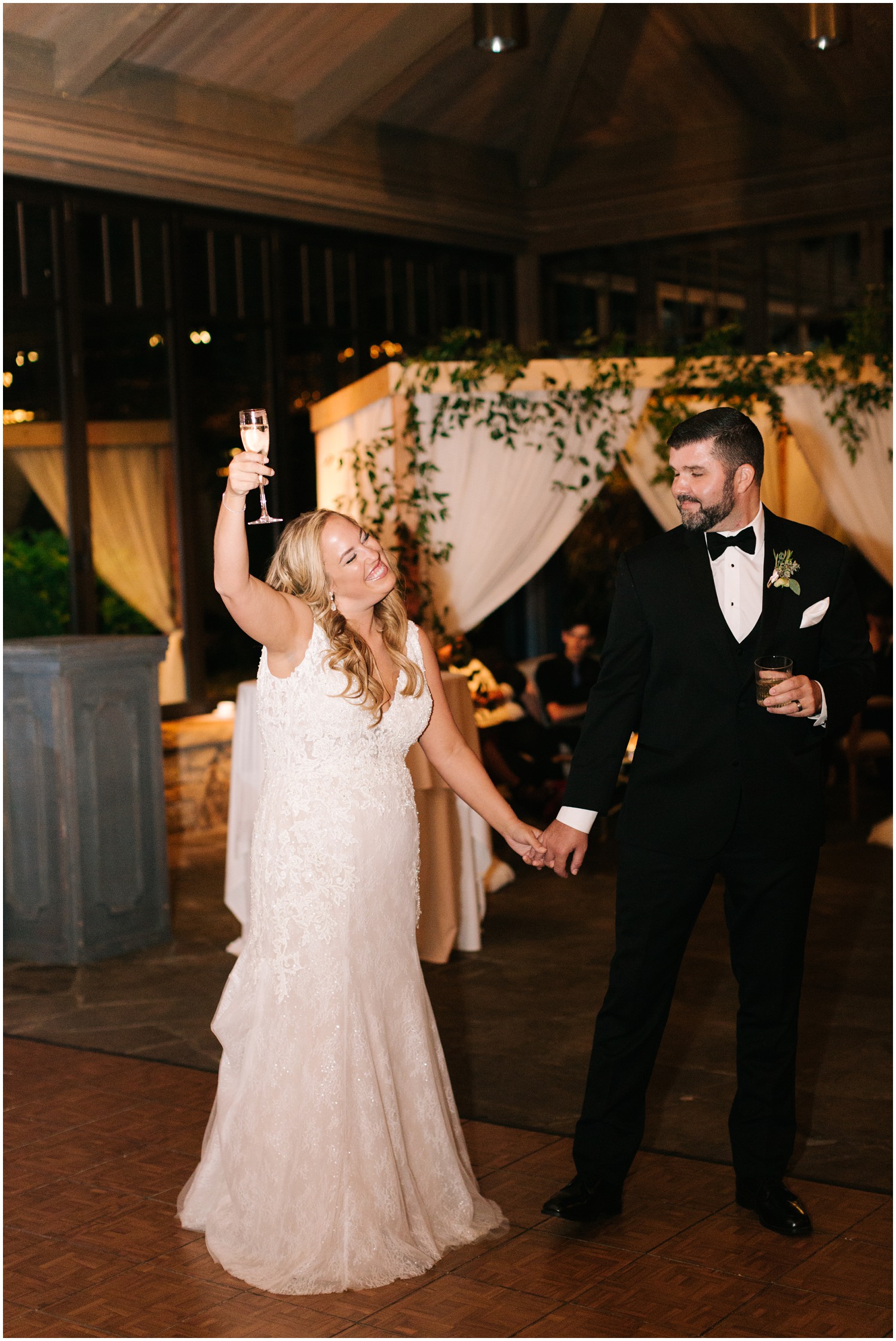 bride toasts guest during reception in NC