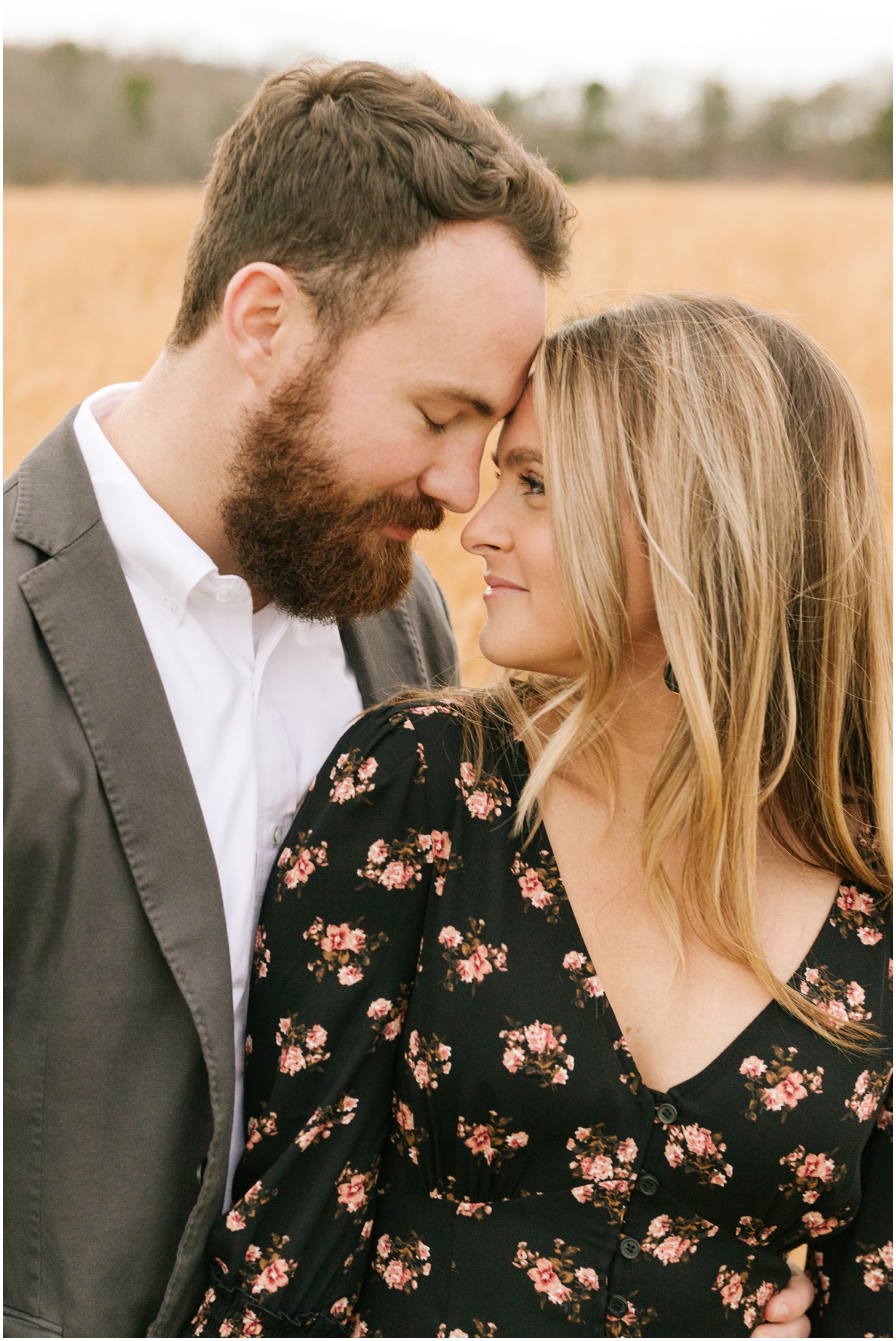 bride looks at groom while he rests head on her forehead during NC engagement photos