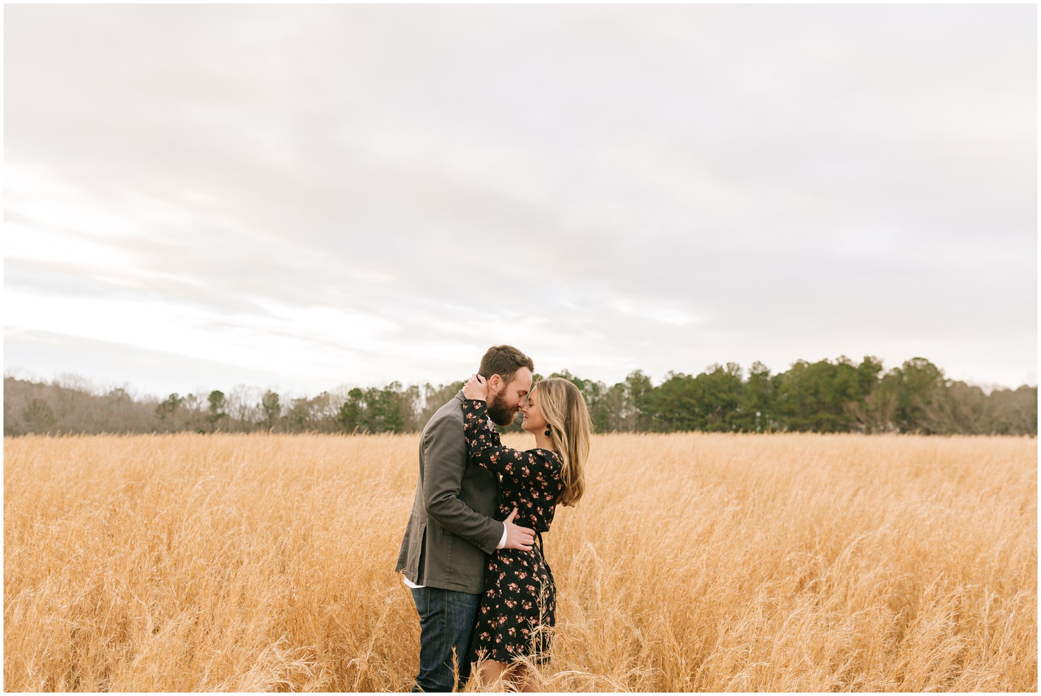 fall engagement portraits of bride and groom in field with Chelsea Renay