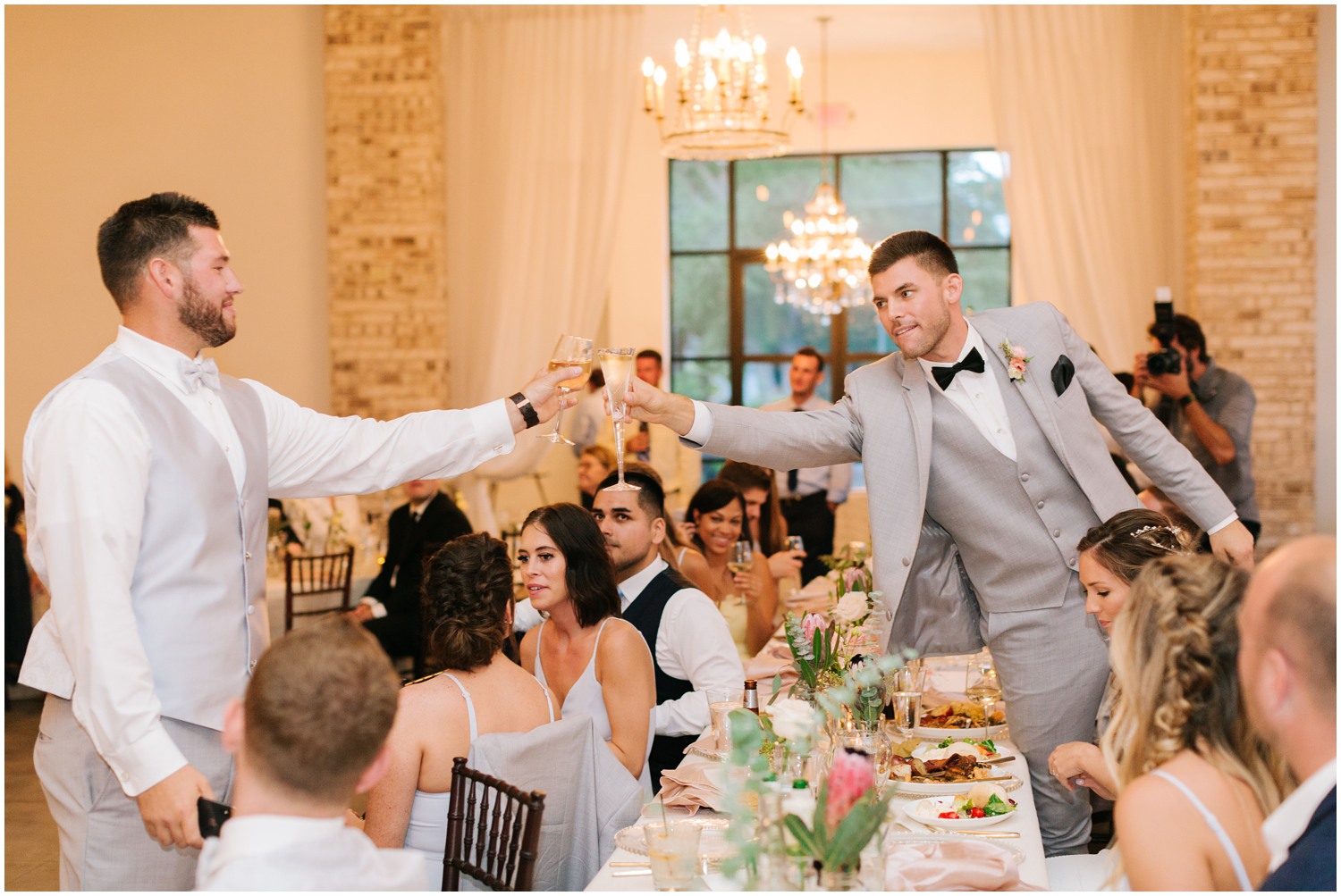 groom cheers with groomsman after wedding toast