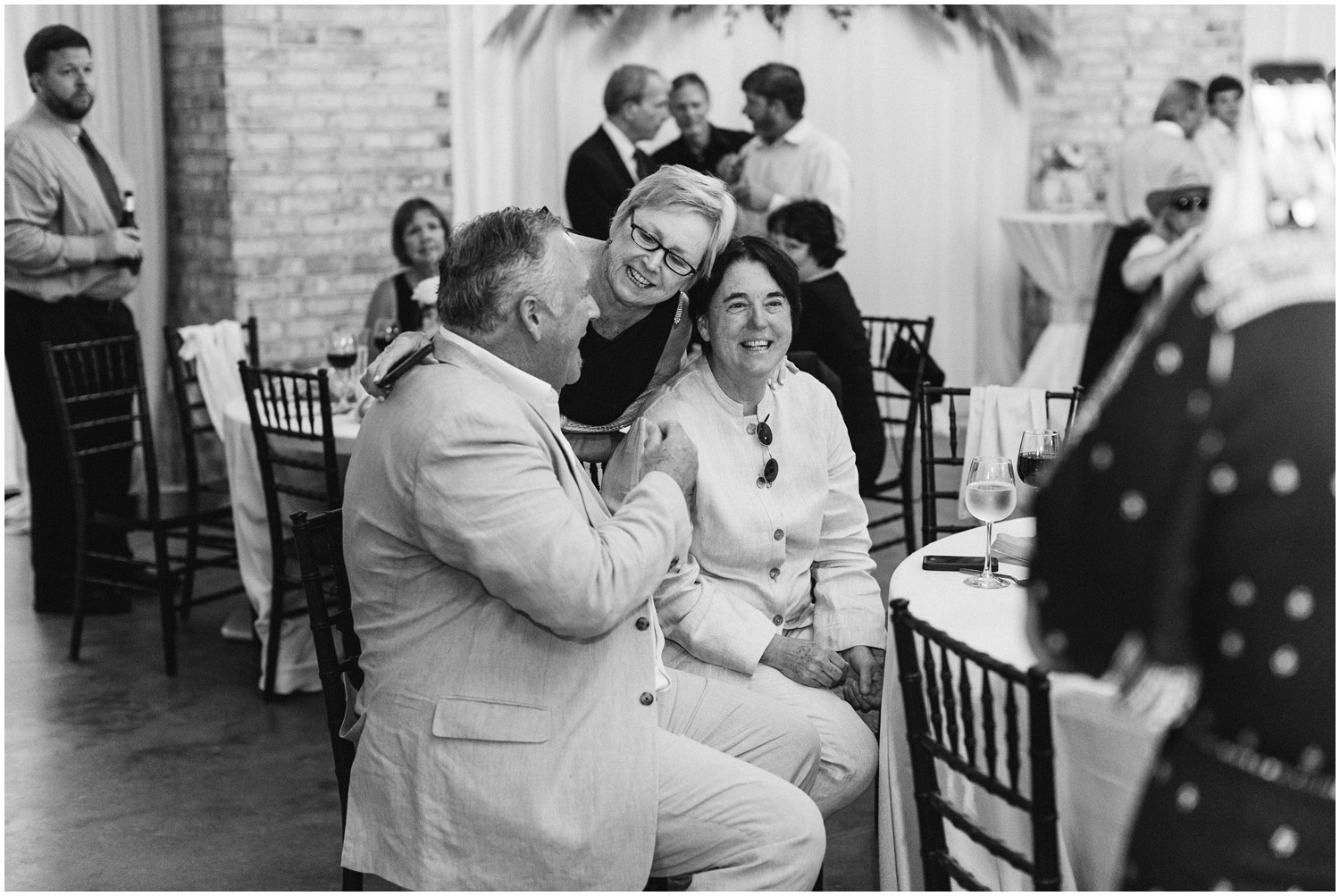 wedding guests smile during reception at table 