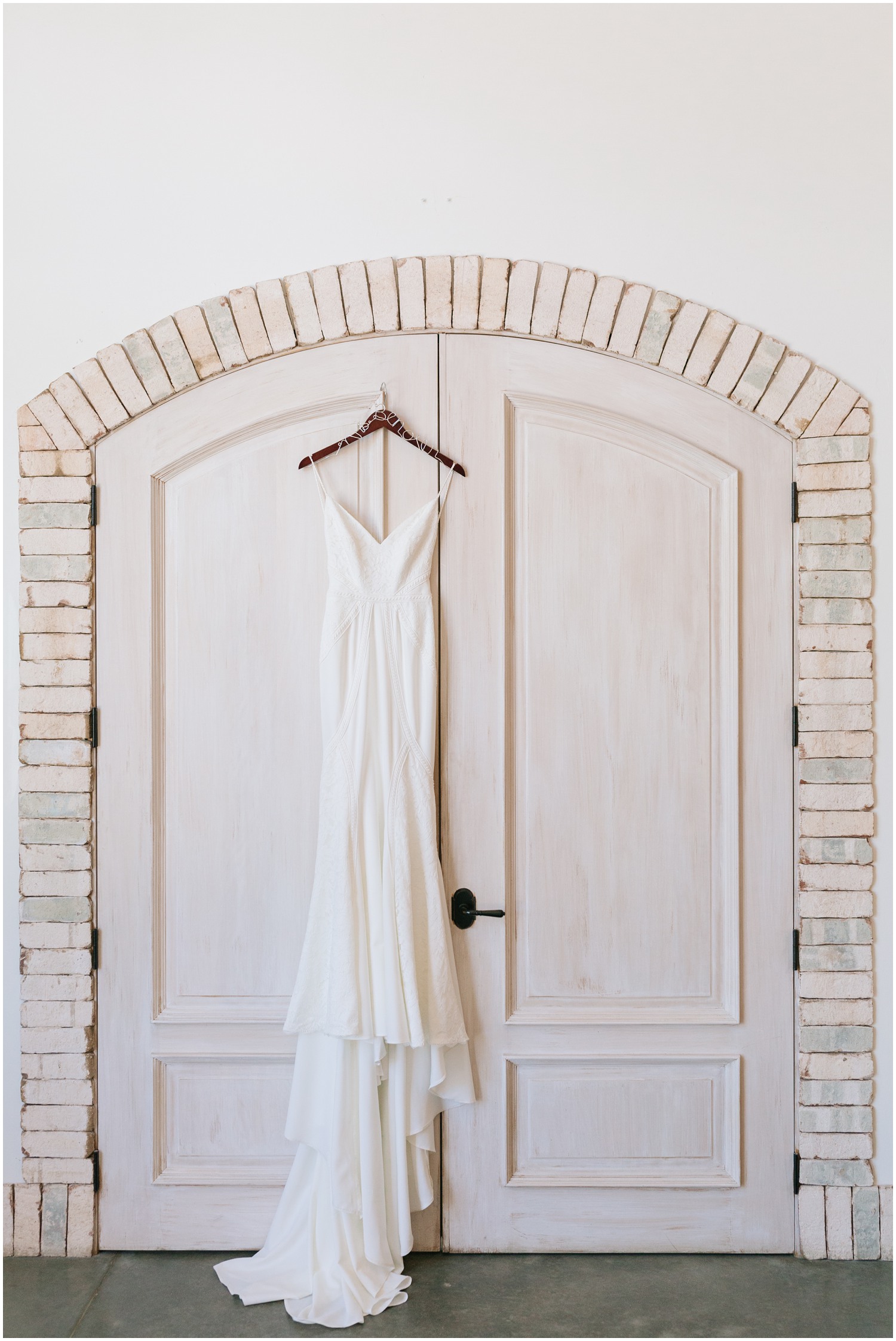 modern wedding dress hangs in front of Wrightsville Manor