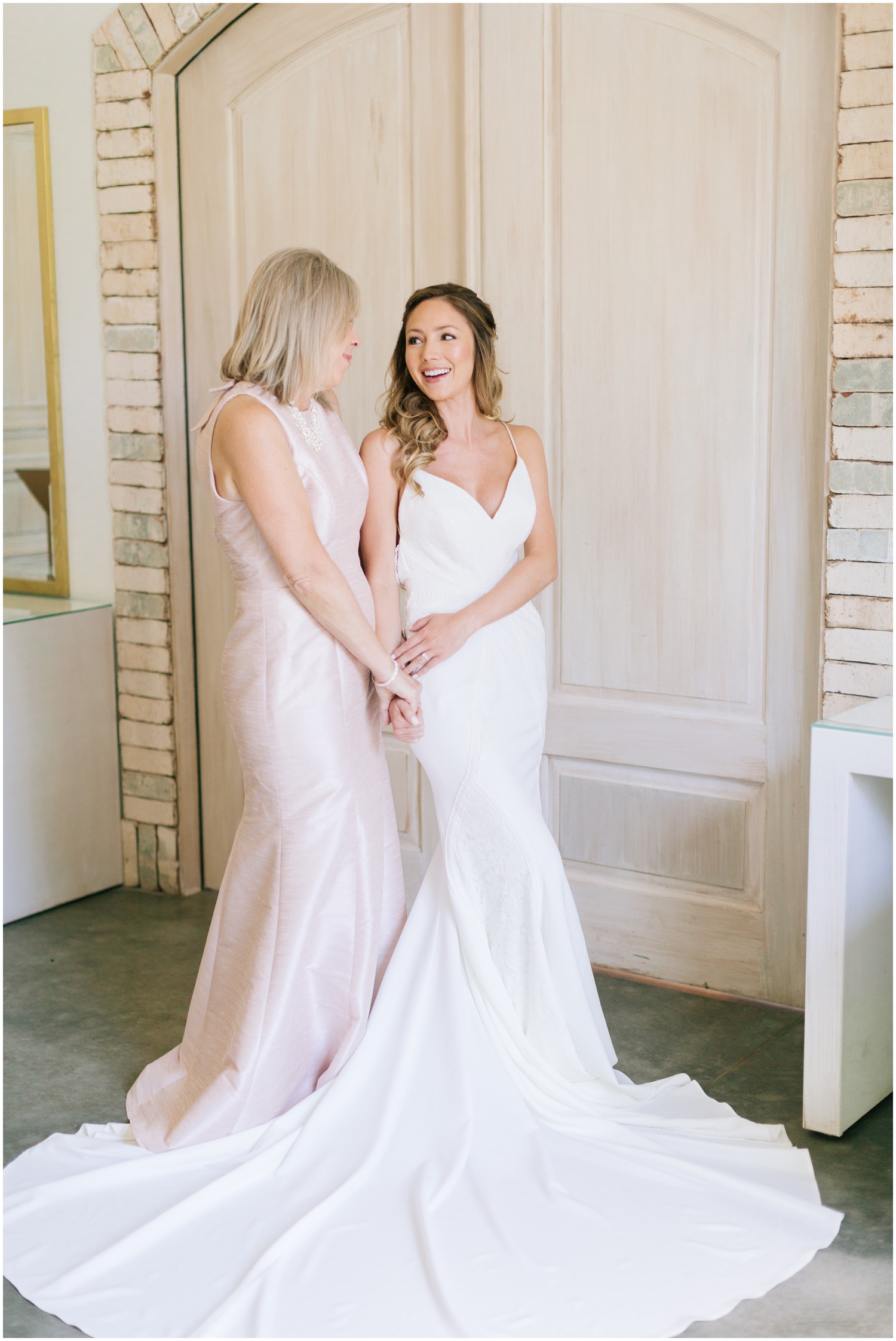 mom and bride prepare for wedding day in bridal suite at Wrightsville Manor