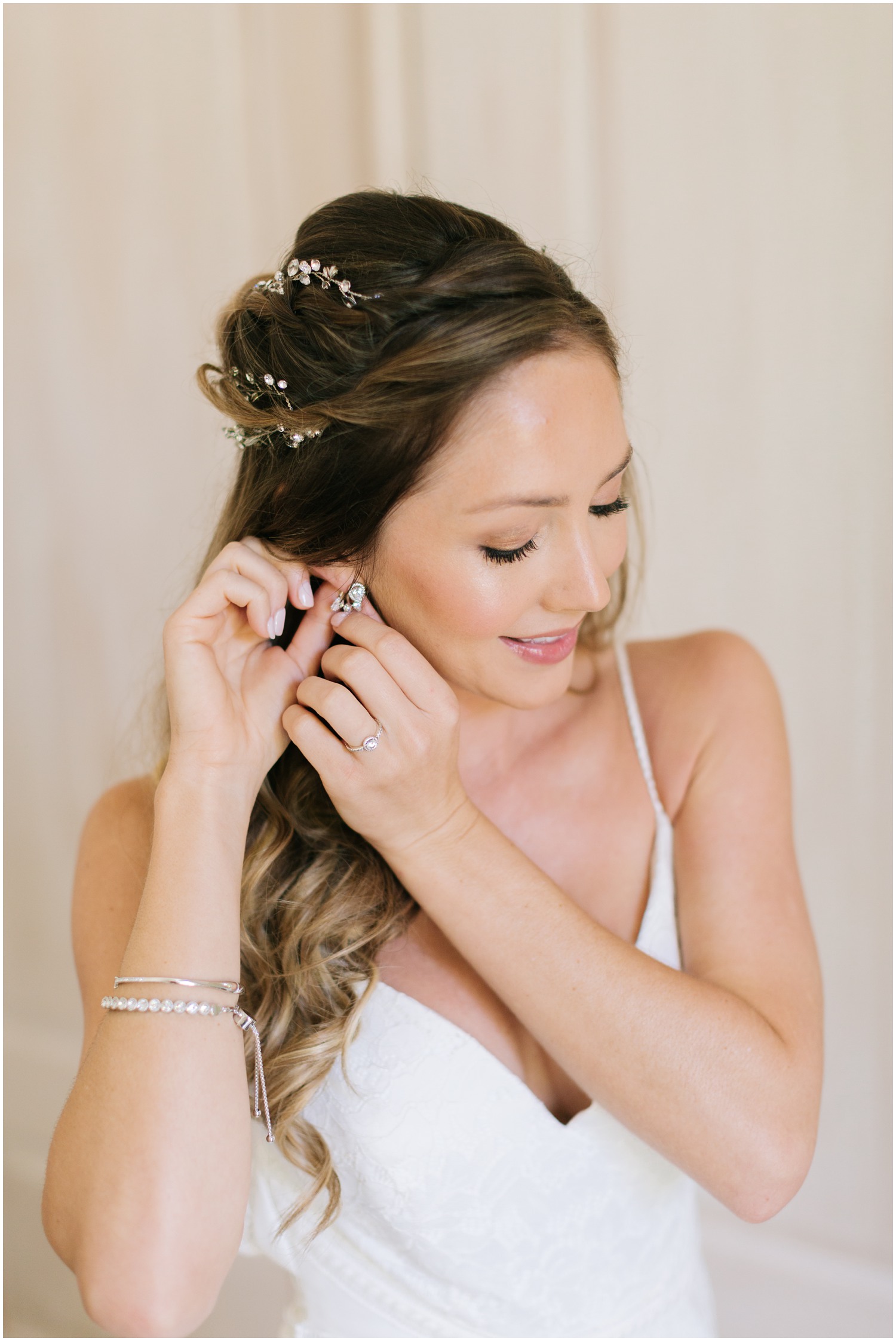 bride adjusts earring before Wrightsville Manor wedding day