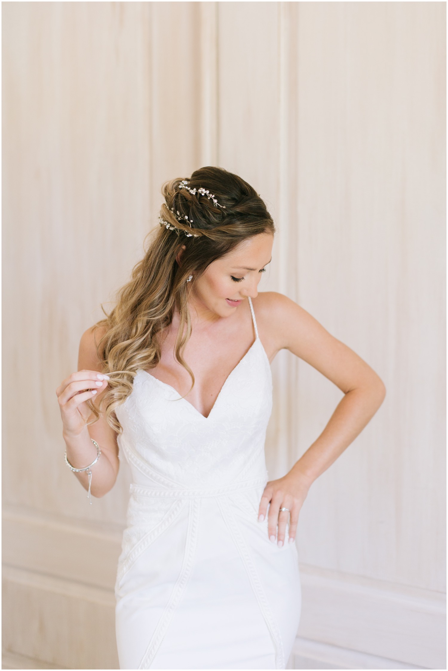 bride plays with hair during bridal portraits at Wrightsville Manor