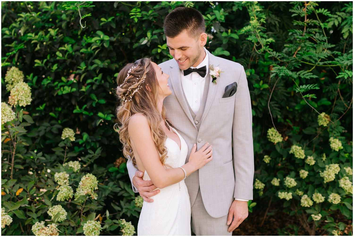 bride and groom look at each other smiling after first look at Wrightsville Manor