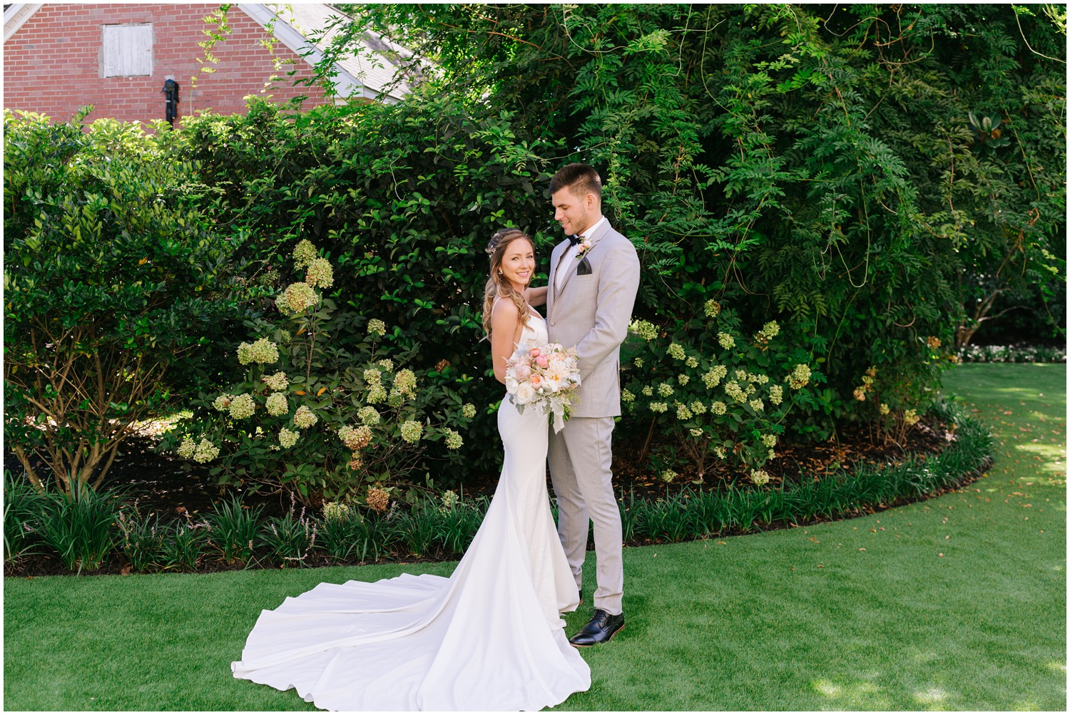 bride and groom pose after first look at Wrightsville Manor