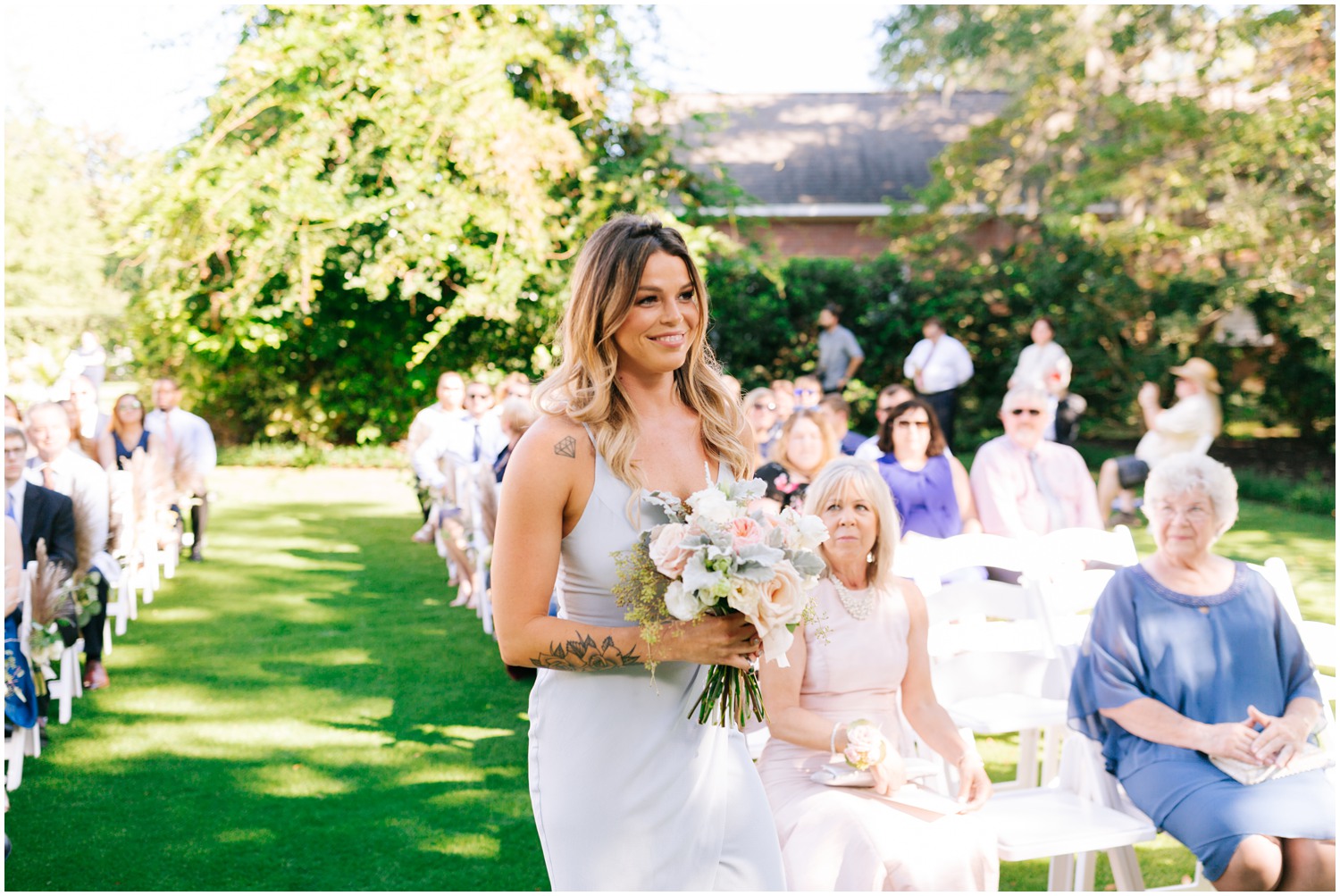 maid of honor walks up aisle in Wilmington NC