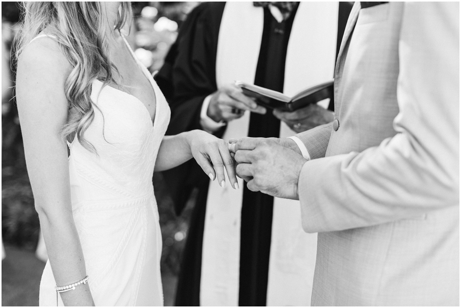 groom puts bride's ring on during Wilmington NC wedding ceremony