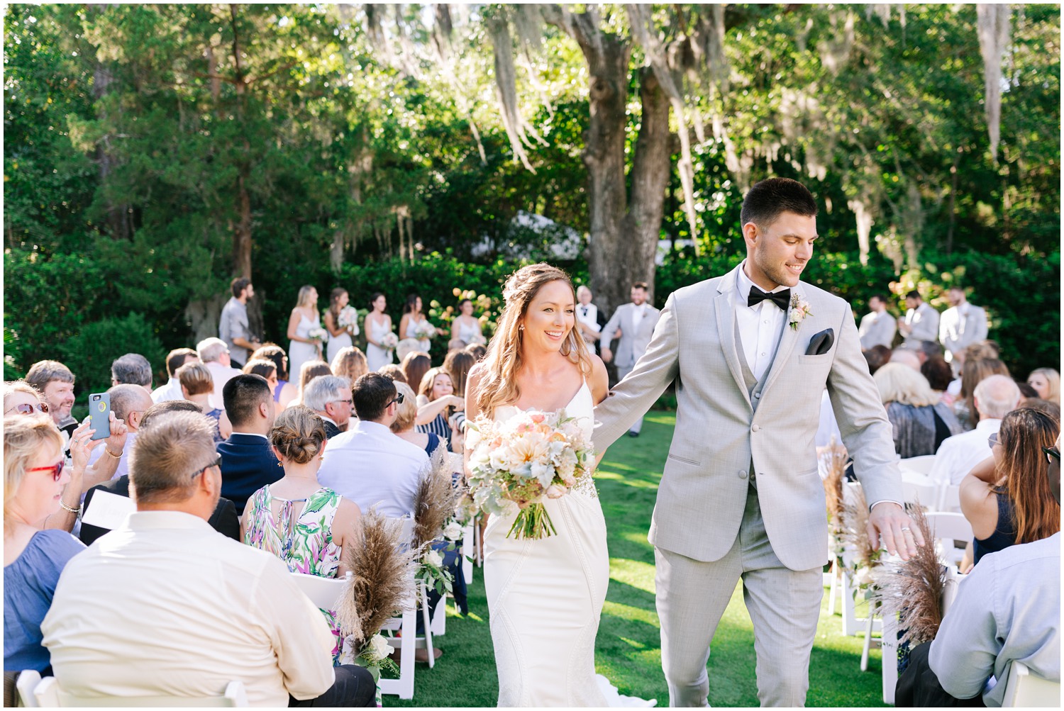 bride and groom walk up aisle at Wrightsville Manor