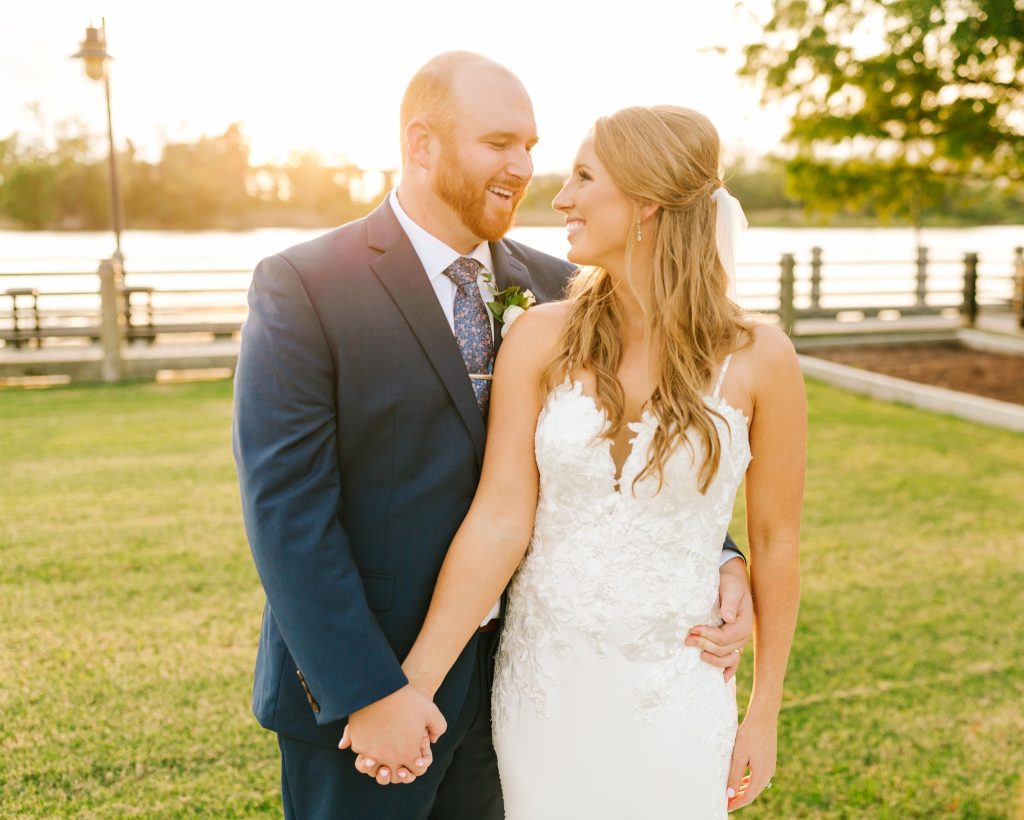 bride and groom smile during portraits in Wilmington NC