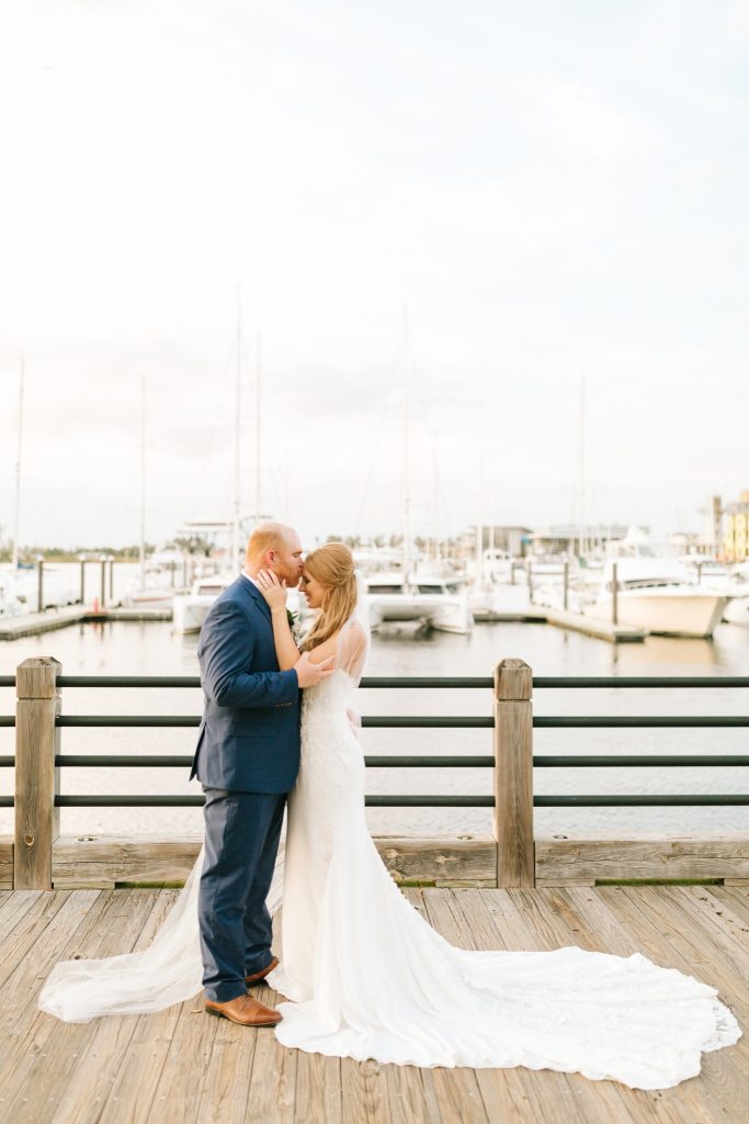 newlyweds pose on dock in Wilmington NC 