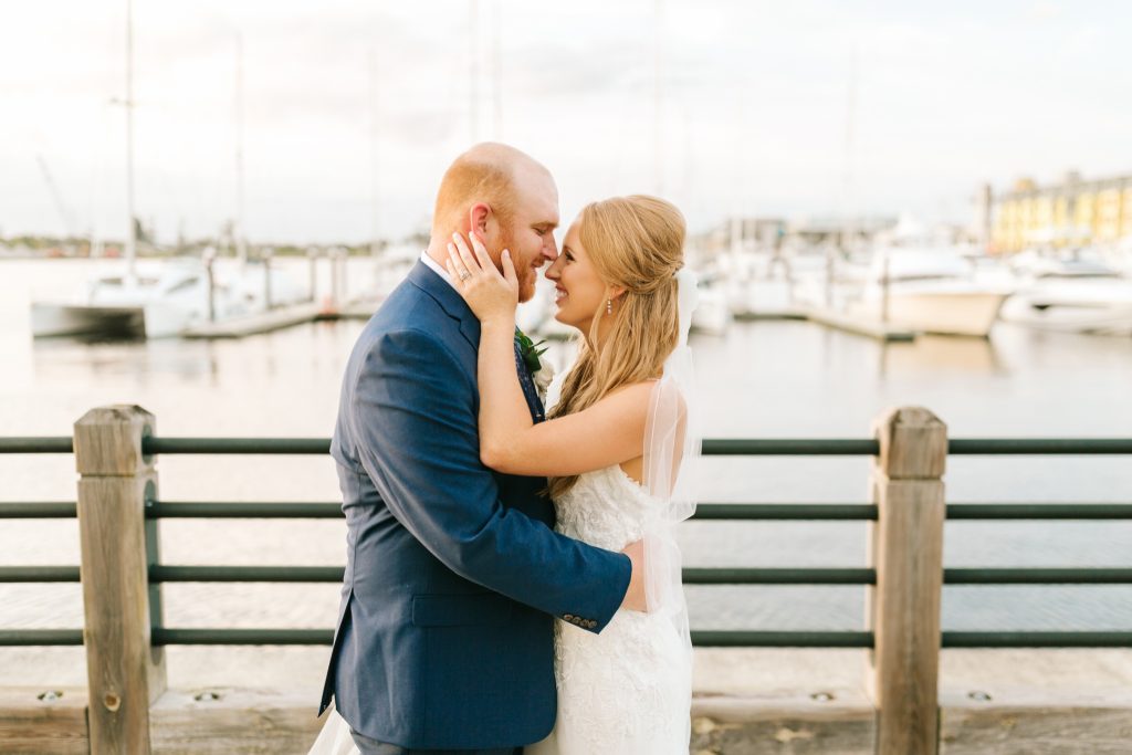 bride and groom pose on docks in Wilmington