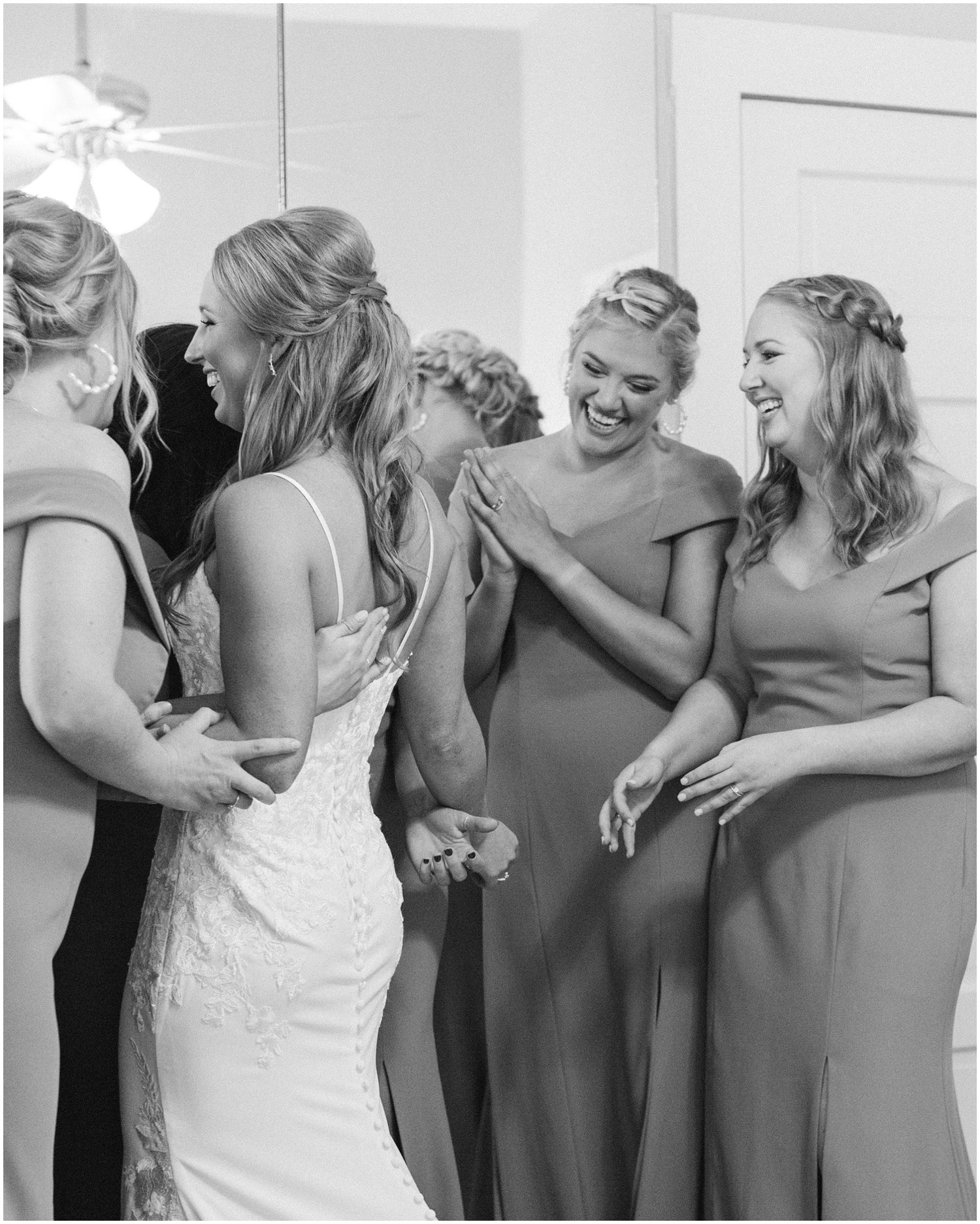 bridesmaids look at bride's gown after first look