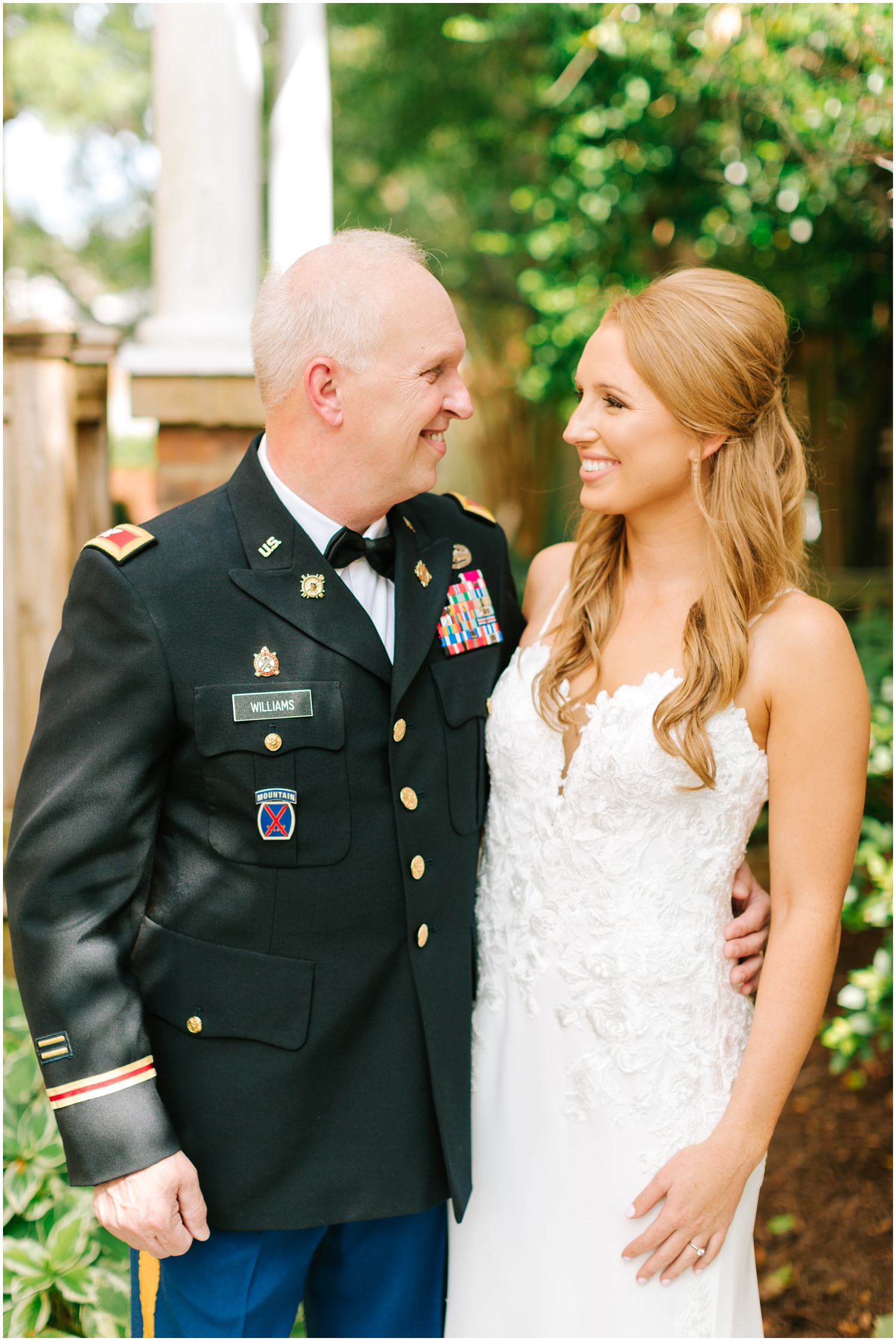 bride poses with dad outside childhood home