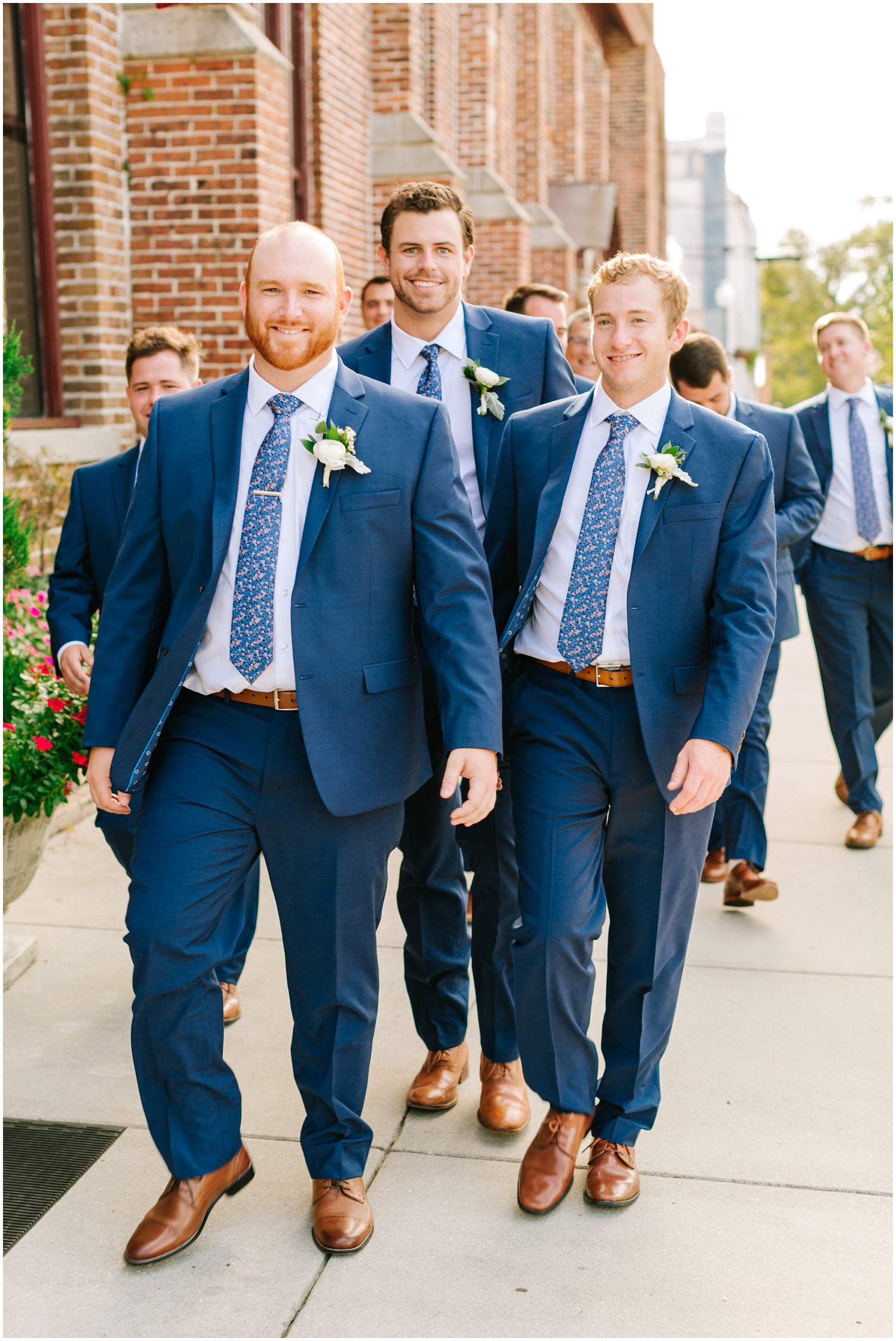 groom walks through Wilmington NC with groomsmen in blue suits