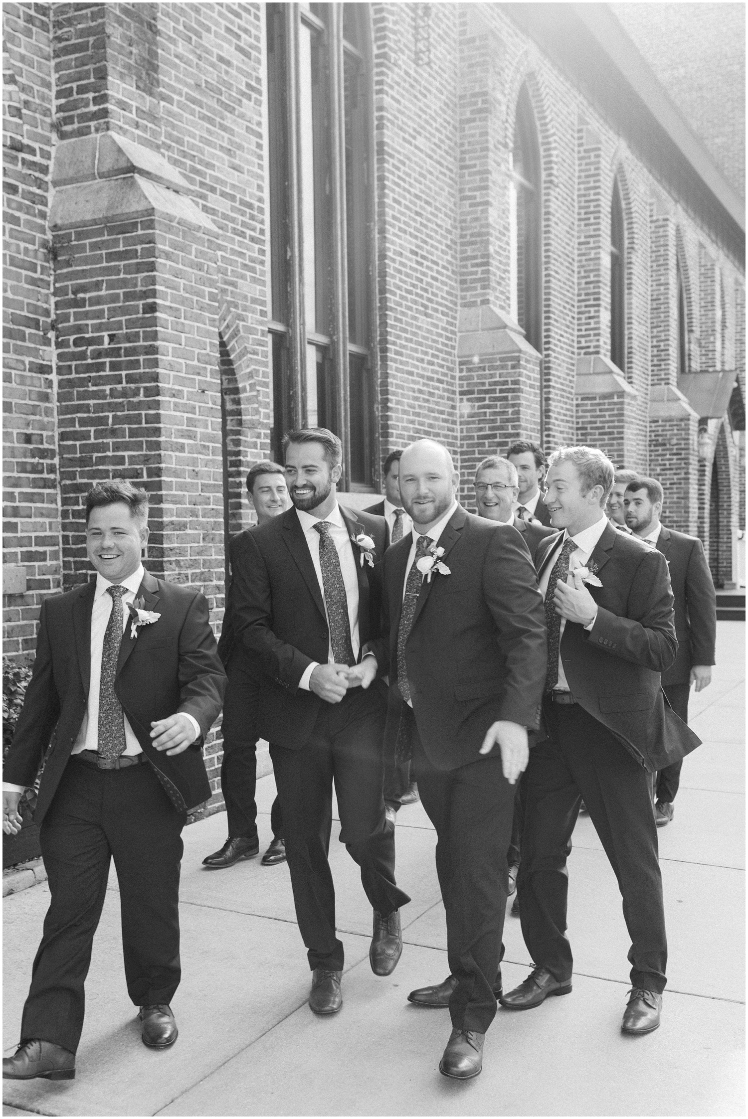 groom and groomsmen walk outside Brooklyn Arts Center