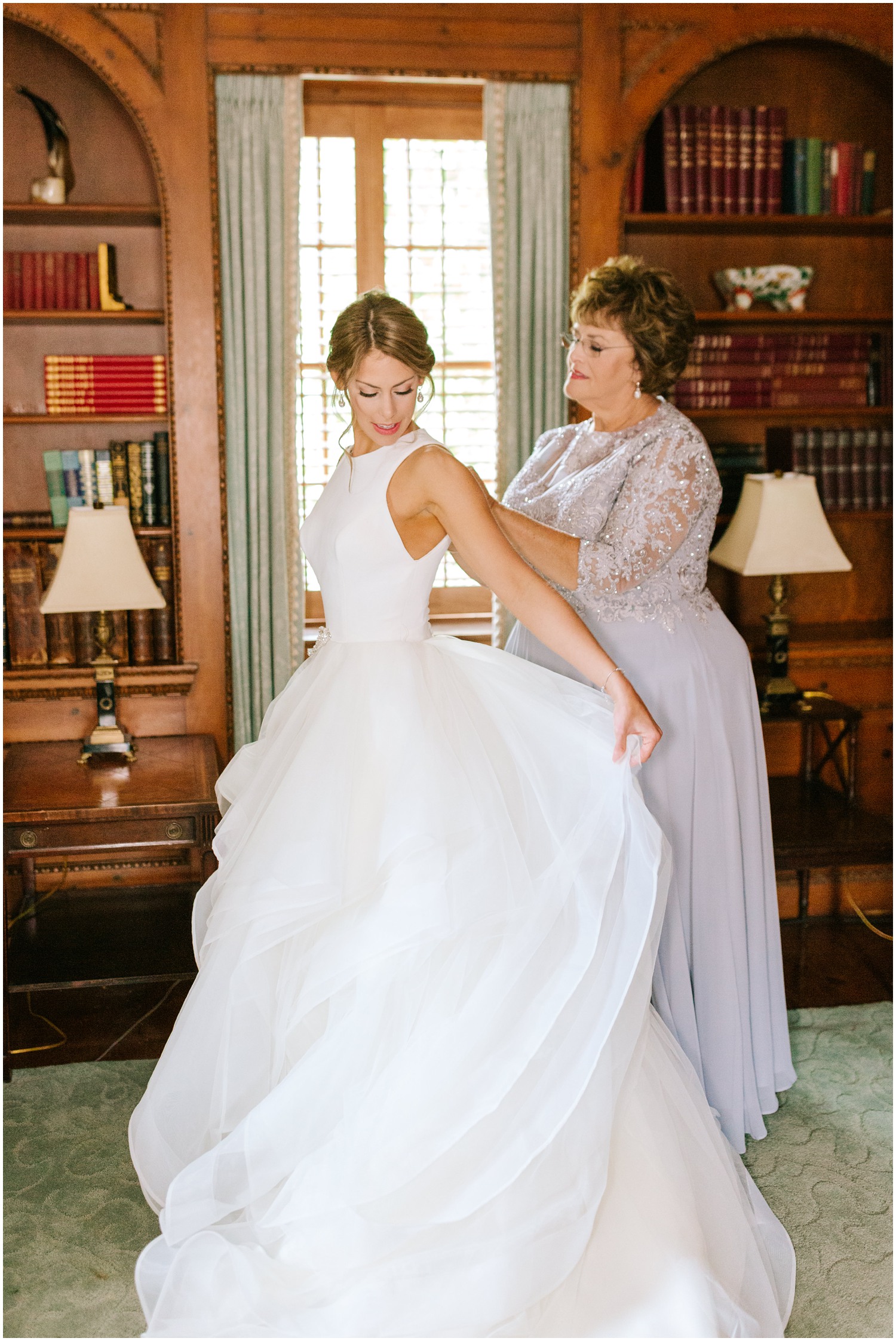 mother buttons up wedding gown for bride at Graylyn Estate