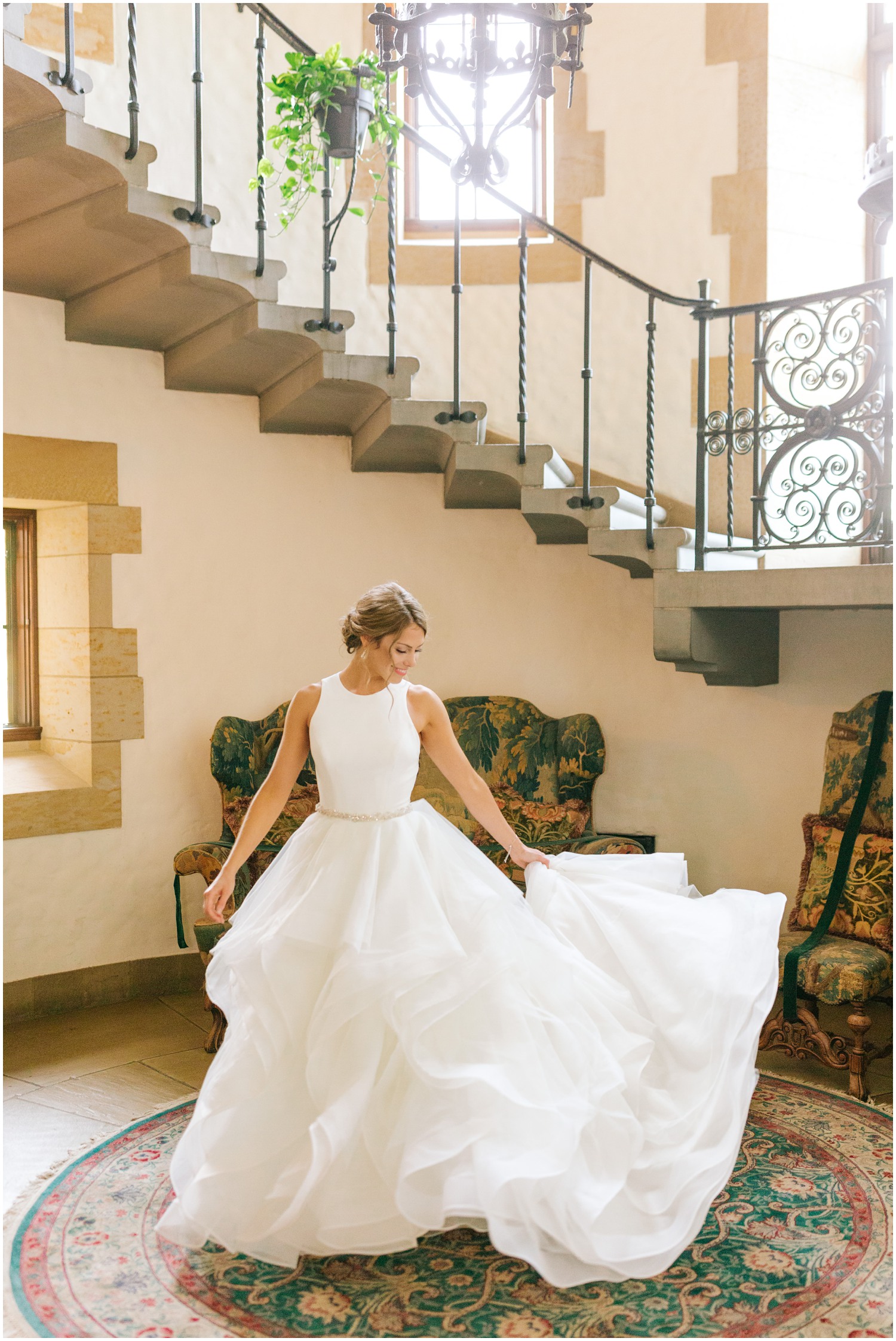 bride twirls in wedding dress in lobby of Graylyn Estate