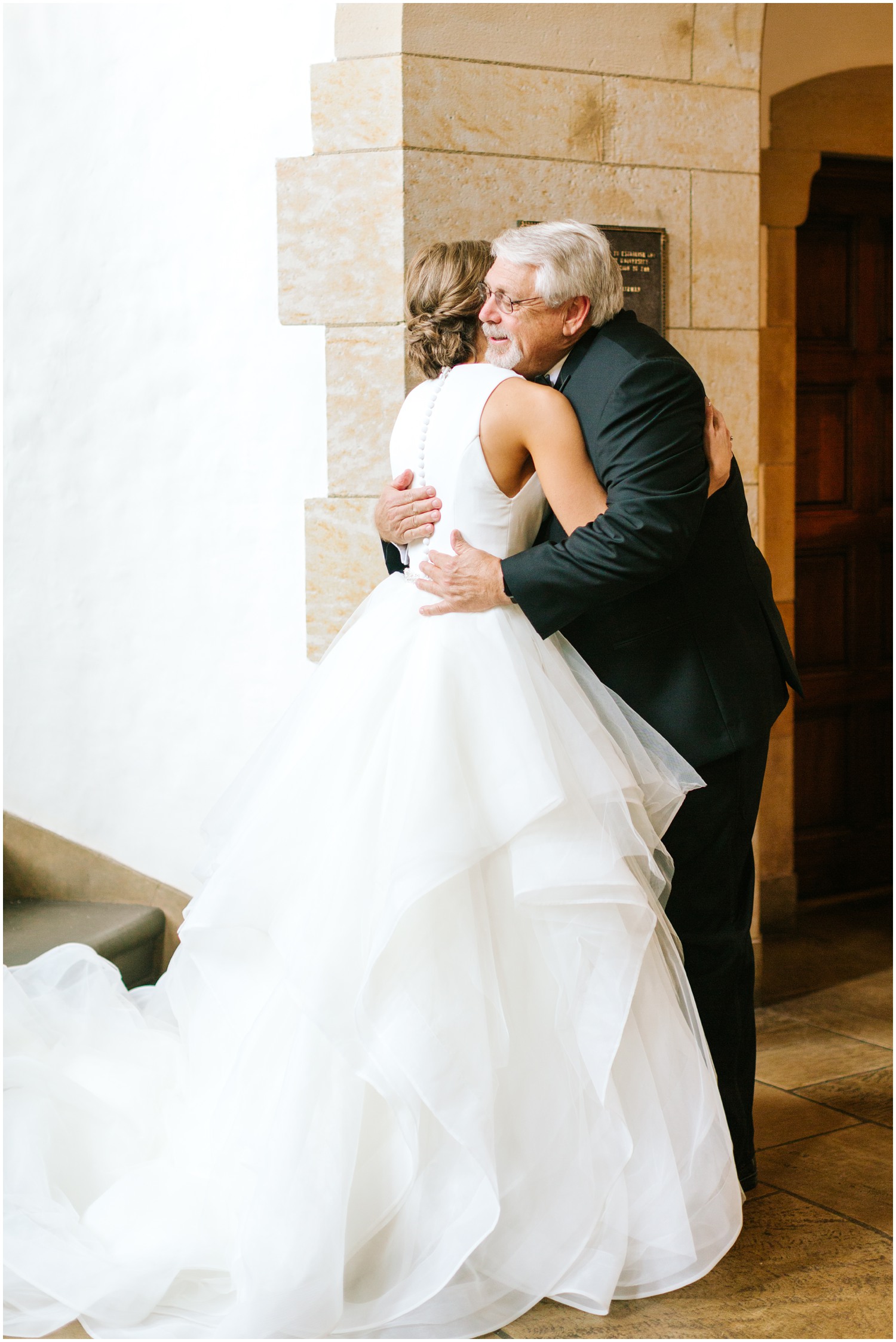 father of bride hugs bride during their first look before NC wedding