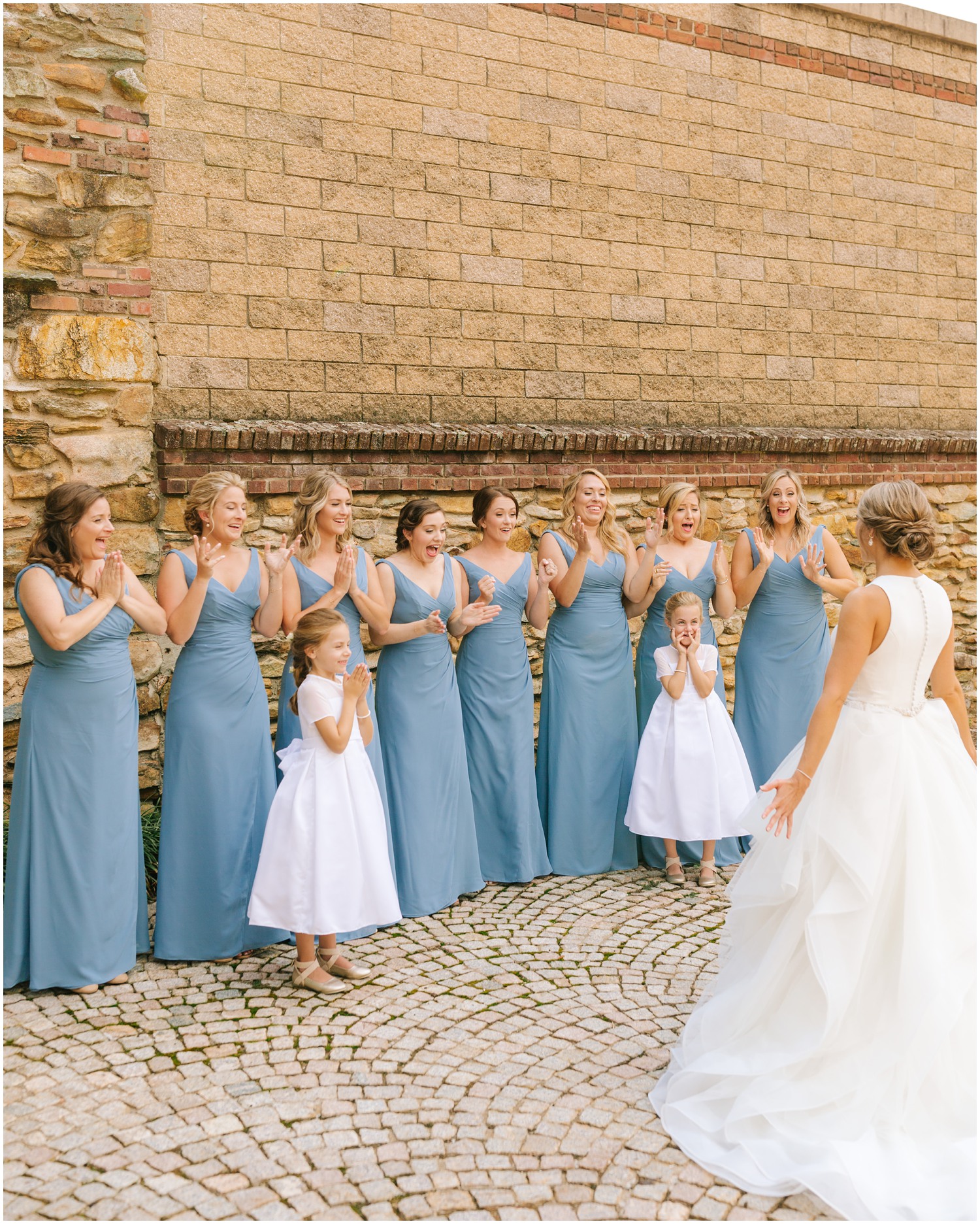 bridesmaids in blue gowns see bride for the first time for NC wedding