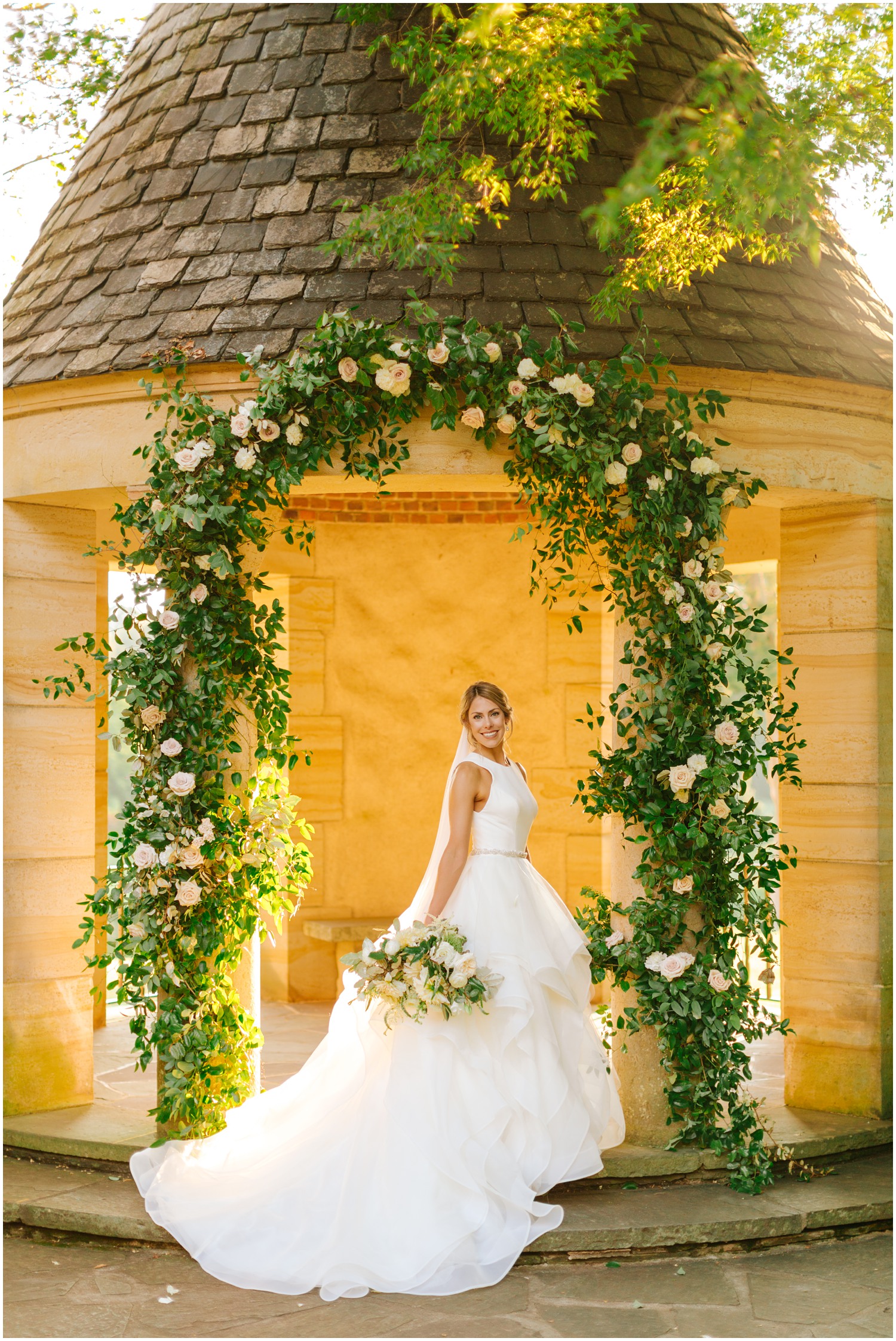 Graylyn Estate bridal portrait under floral archway with green and white flowers