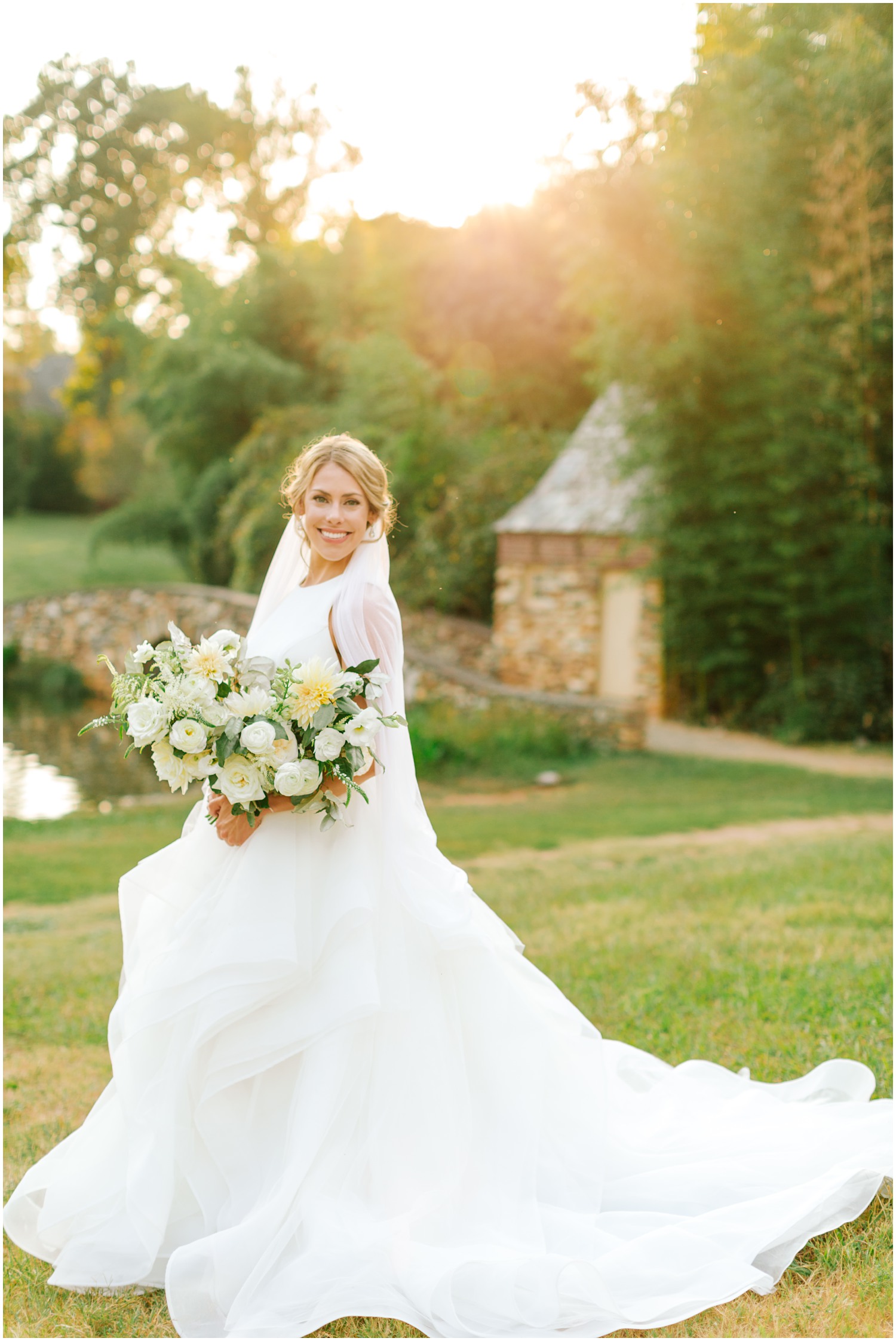bridal portrait of bride in wedding dress with long veil and all white bouquet