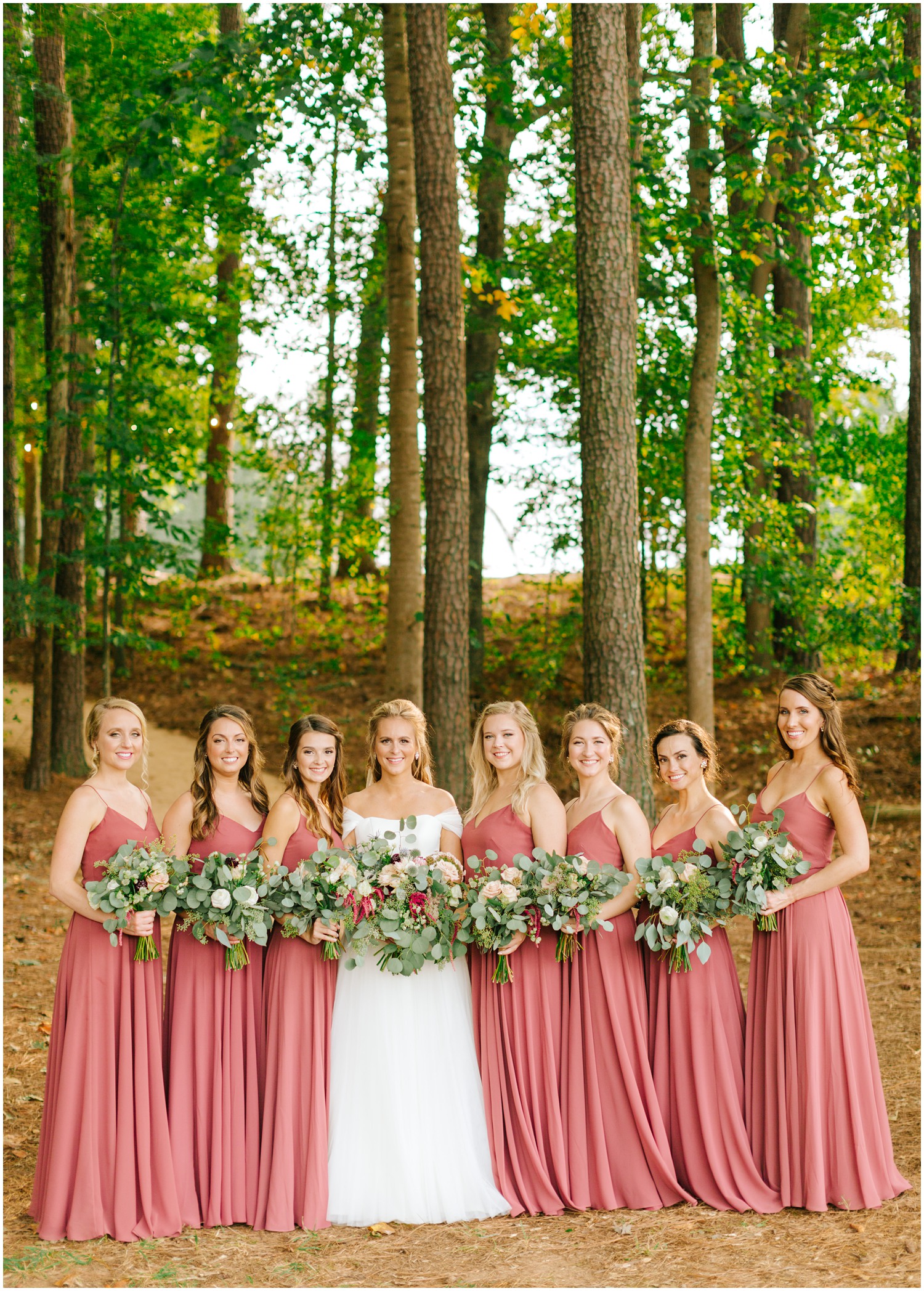 bride and 7 bridesmaids in pink gowns photographed at The Meadows Raleigh