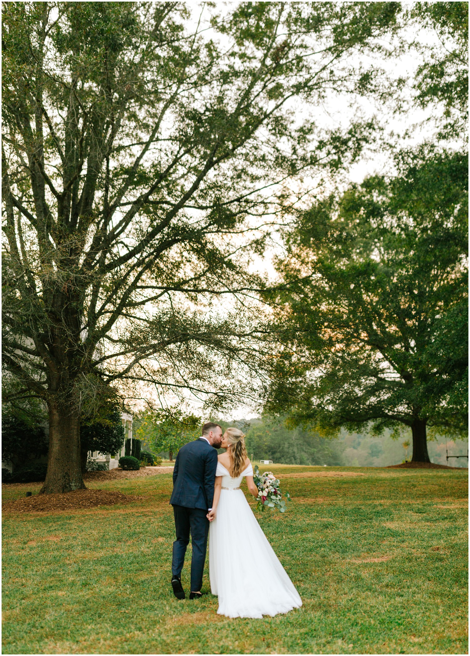 North Carolina couple kisses during sunset photos at The Meadows Raleigh