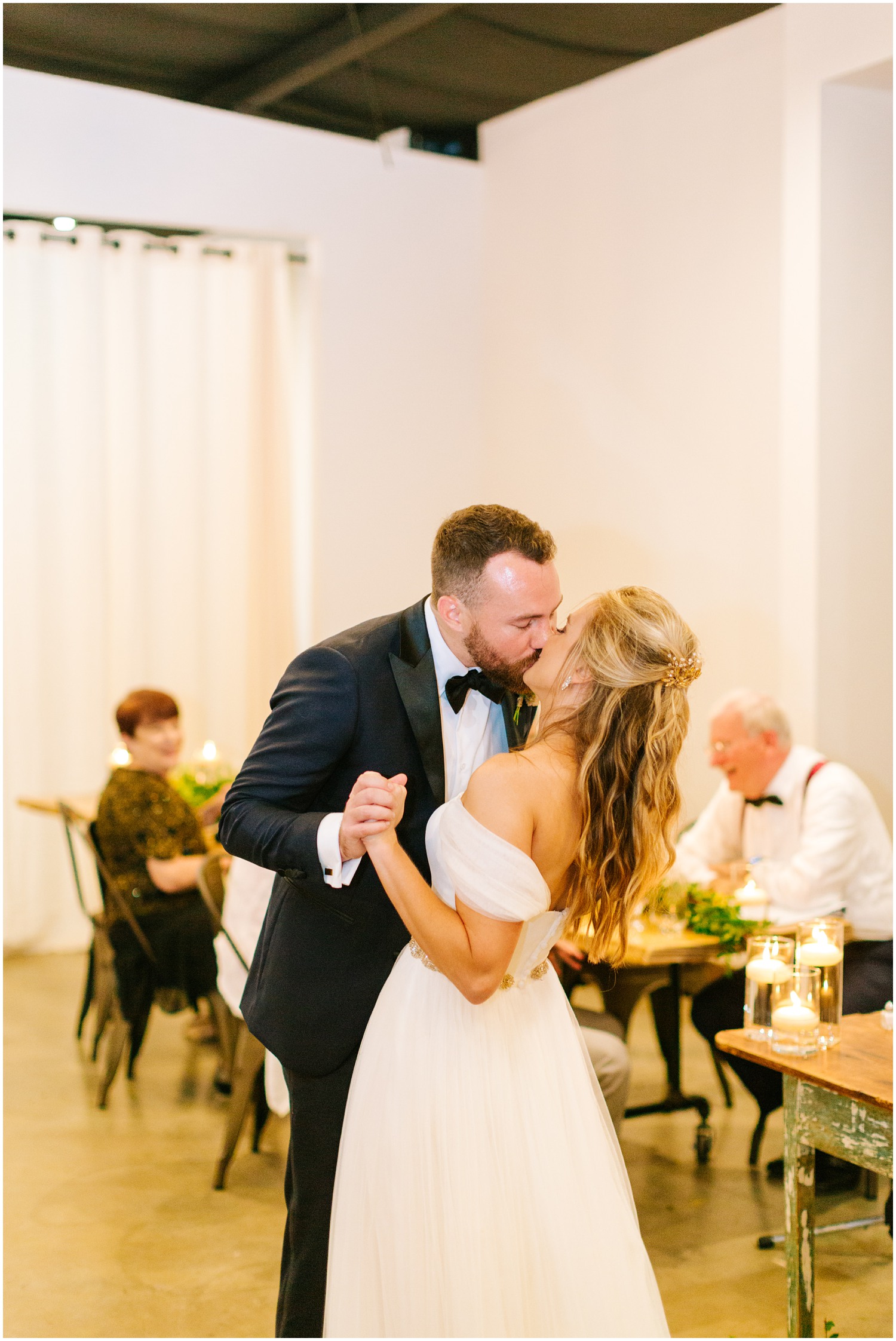 bride and groom kiss on dance floor at Wedding at The Meadows Raleigh