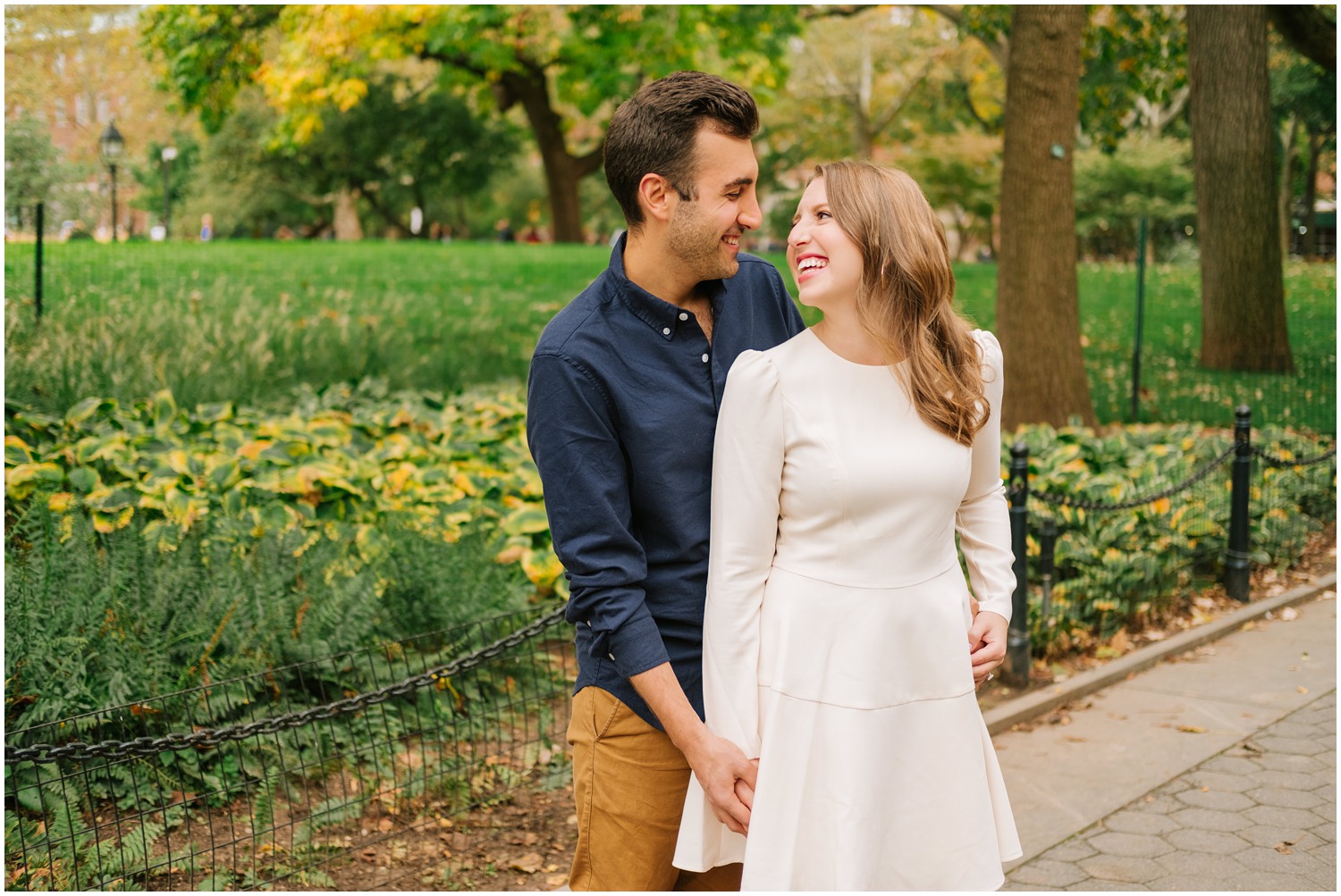 bride laughs at groom during West Village & Dumbo engagement photos