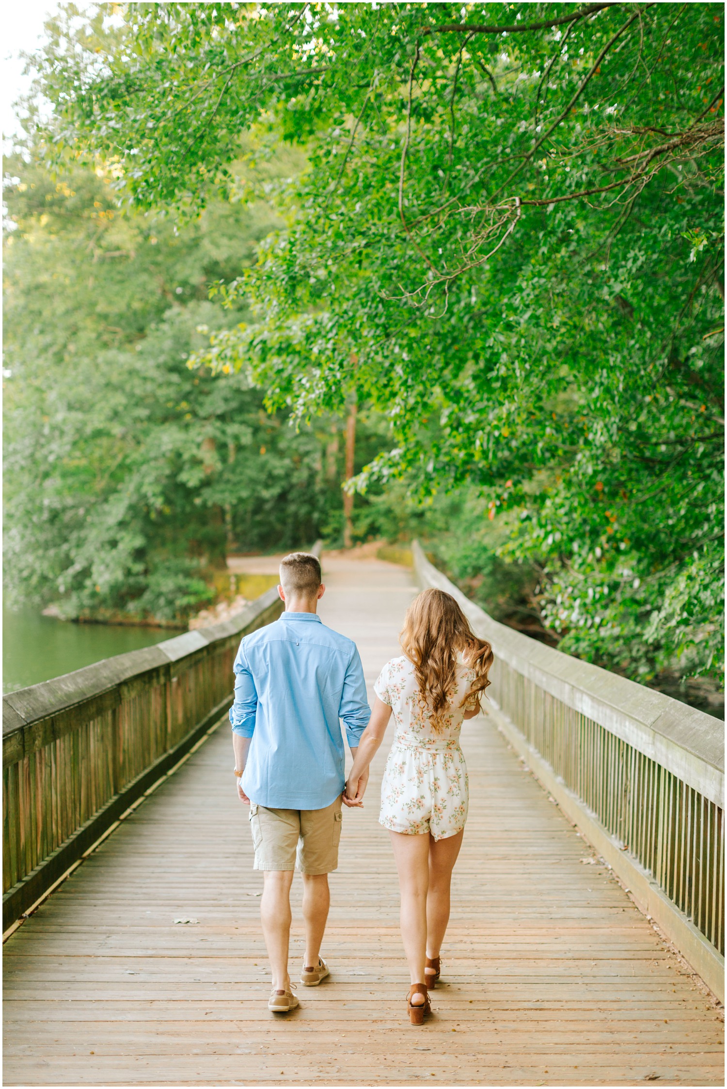 couple walks along bridge in Lake Lyn