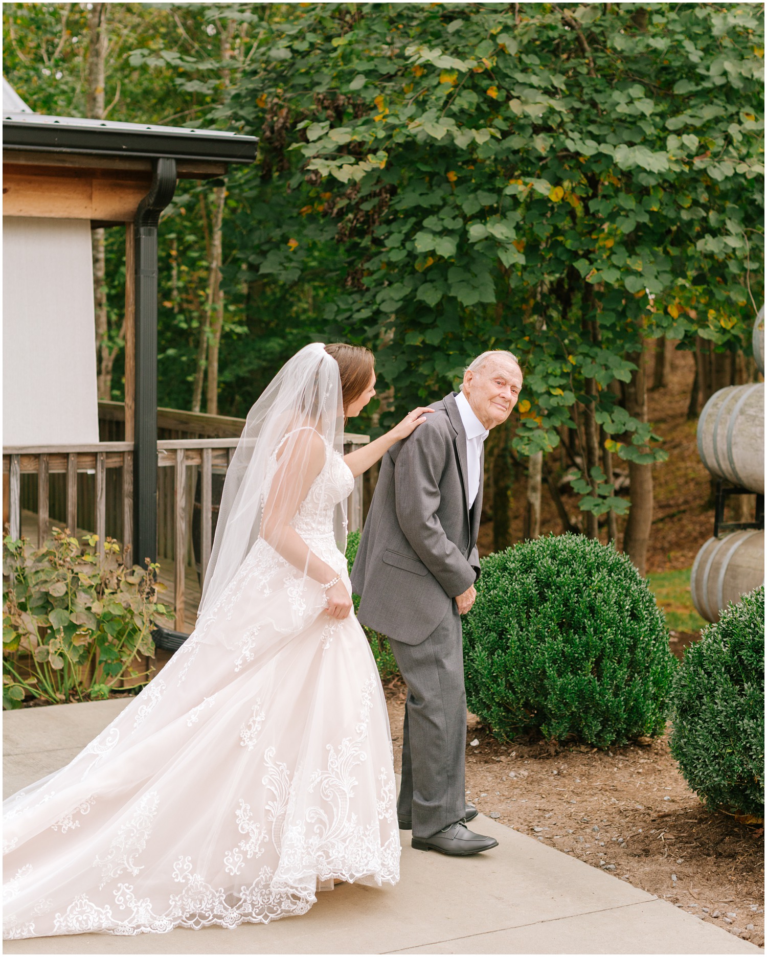 bride taps grandfather on shoulder before Medaloni Cellars wedding