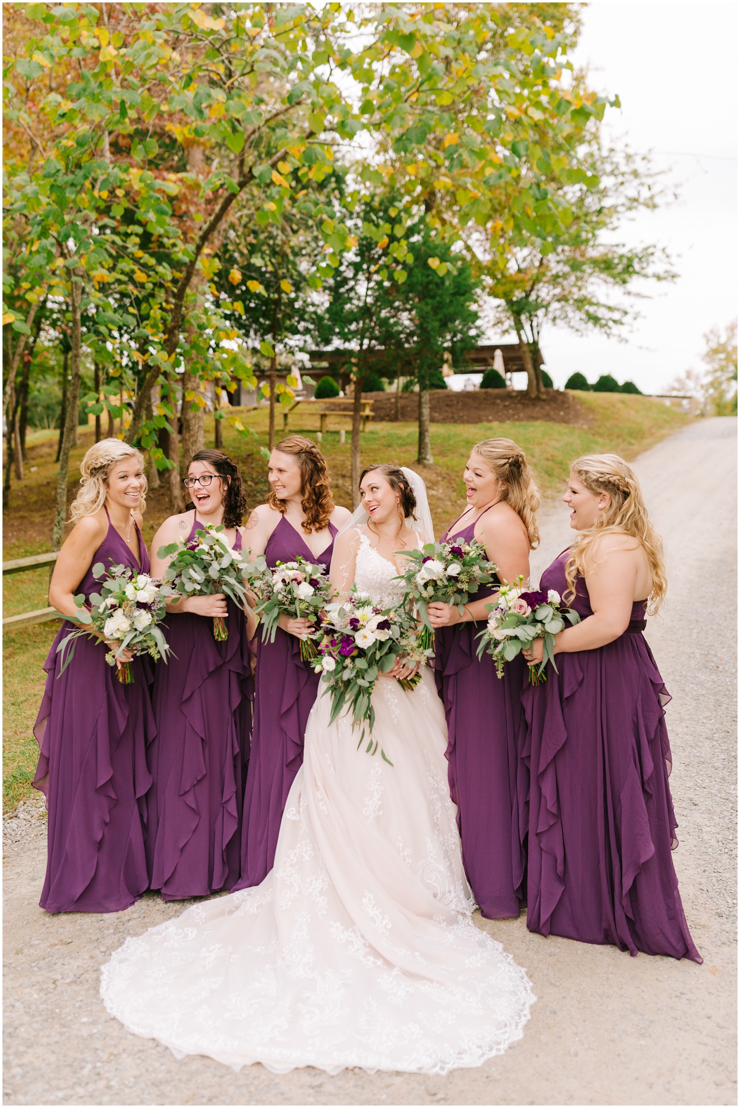 bride laughs with bridesmaids before fall wedding at Medaloni Cellars