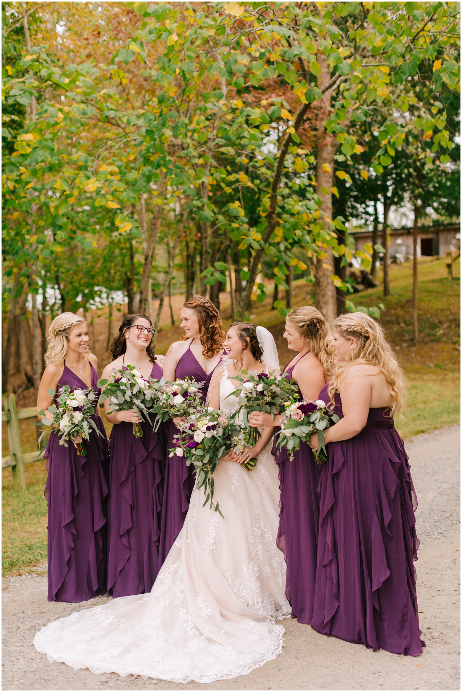 bridesmaids pose with bride before fall ceremony