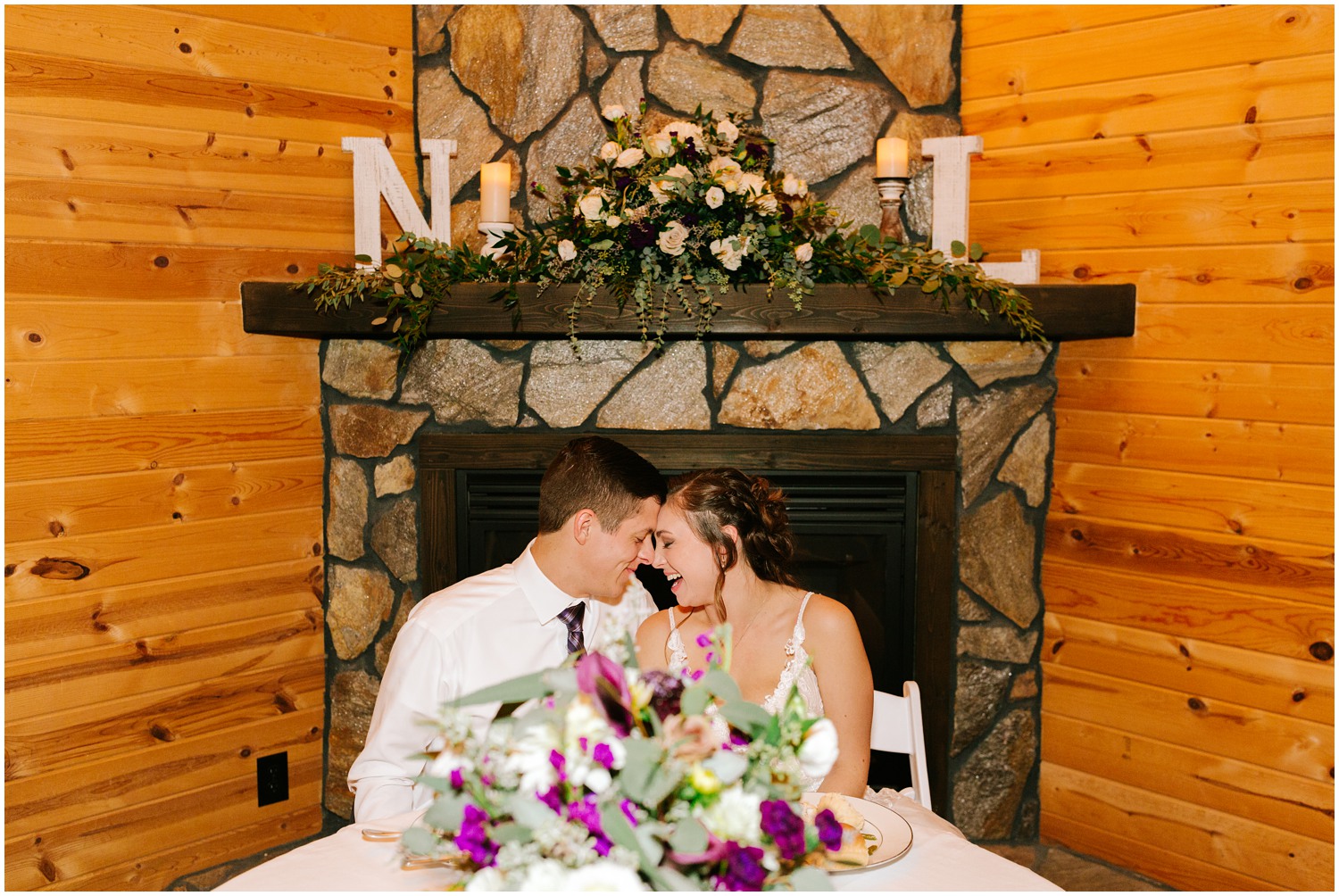 bride and groom pose by fireplace at Medaloni Cellars