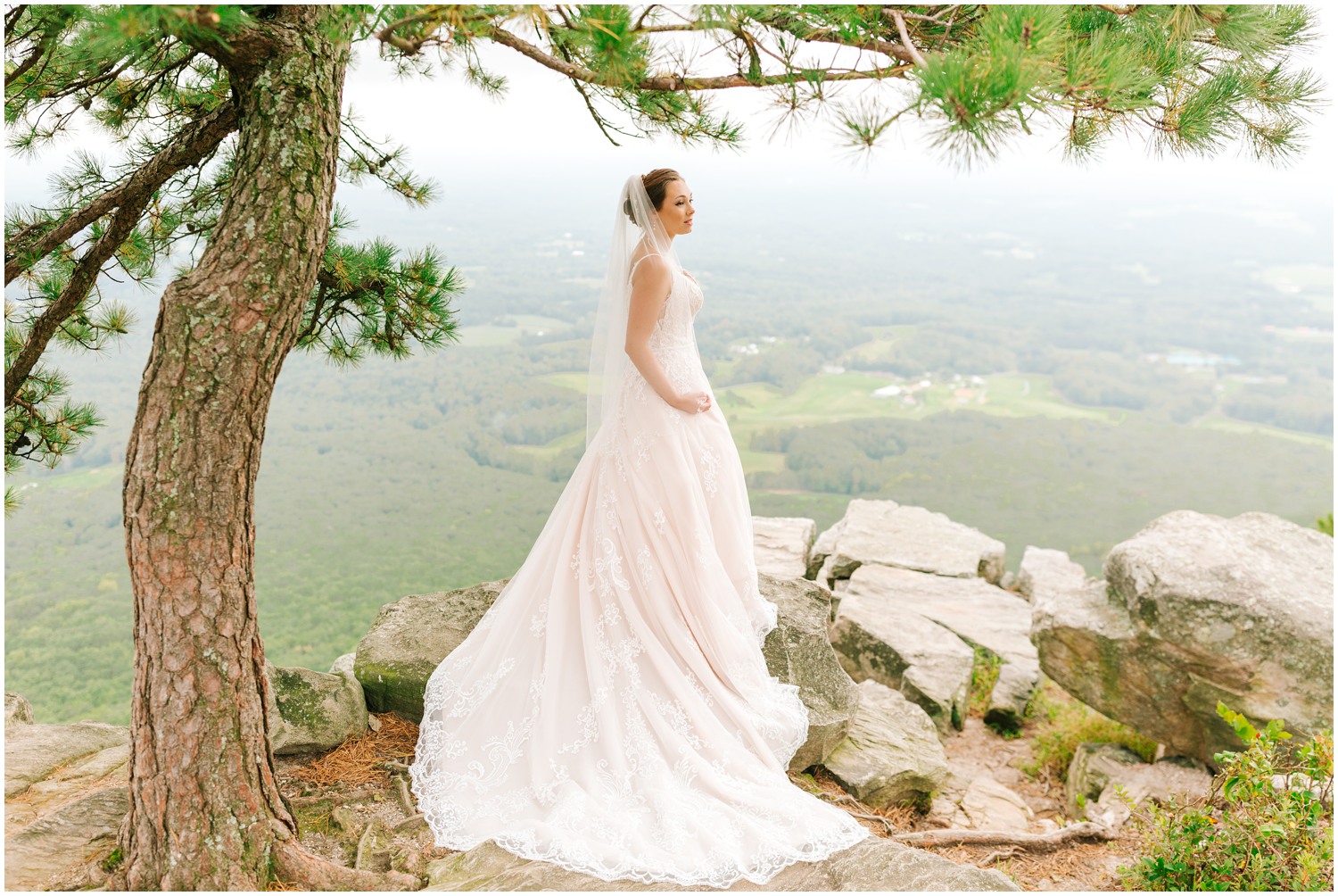 Pilot Mountain bridal session with bride standing with hand on hip