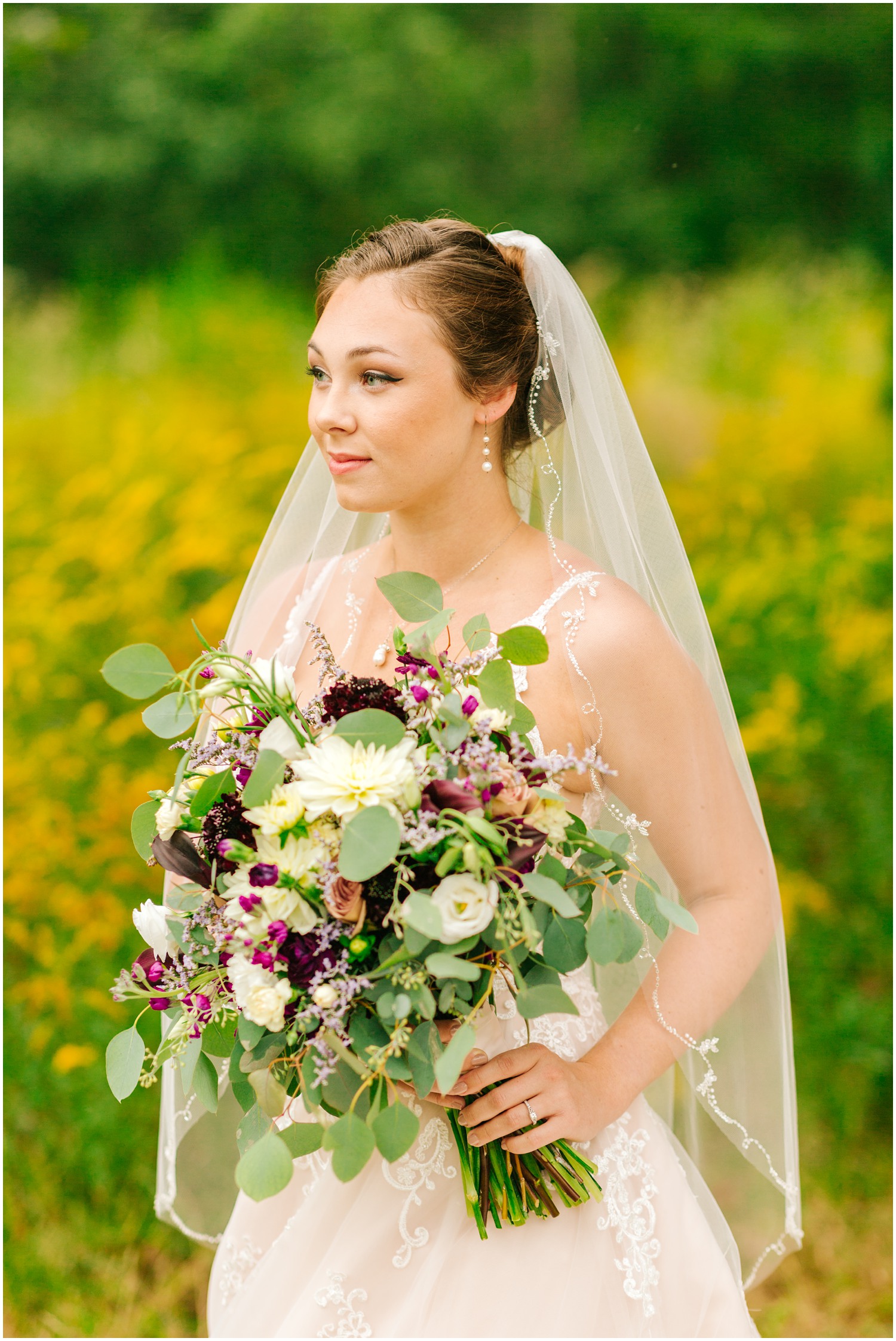 bride holds fall bouquet during bridal session on mountain