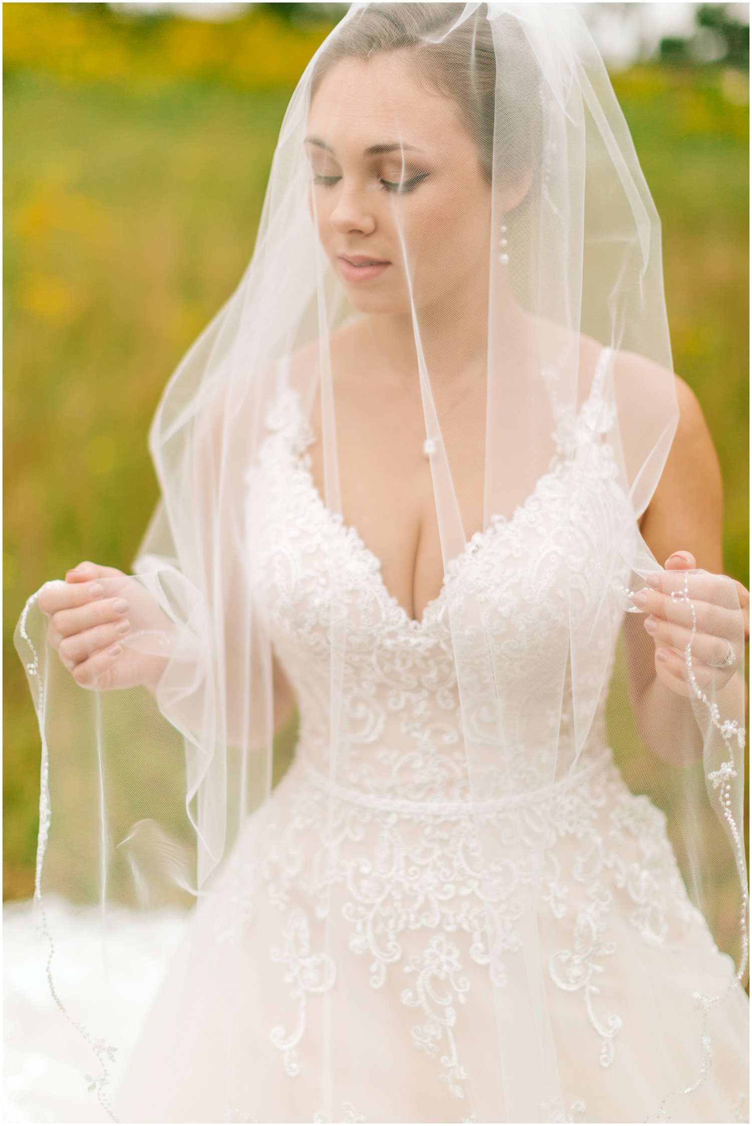 portrait of bride with veil over face in NC state park