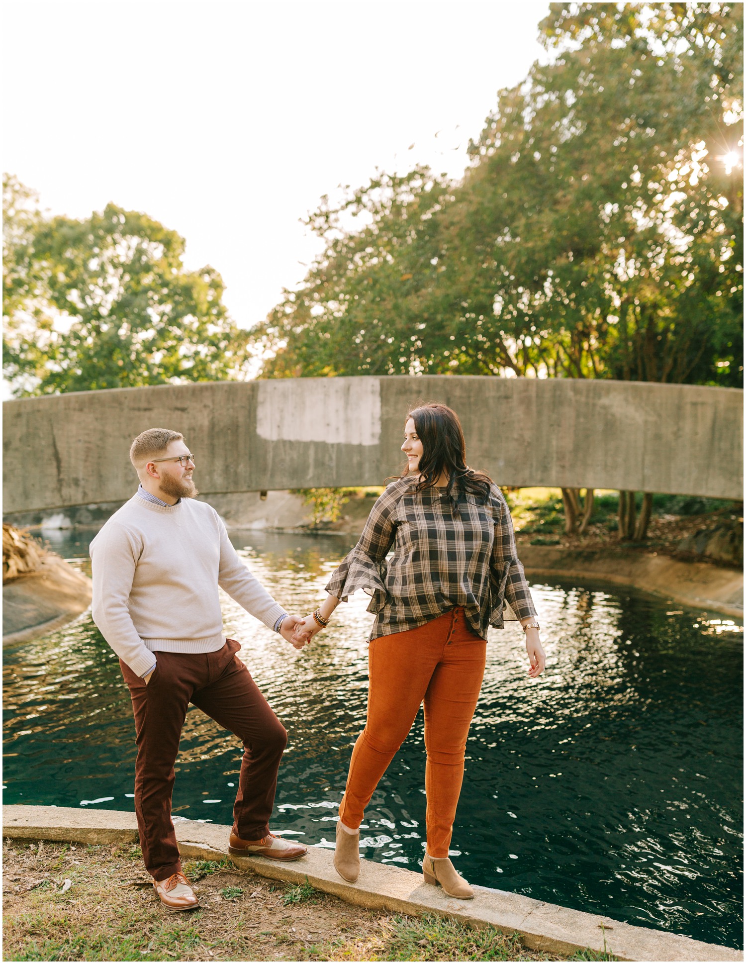 Charlotte Engagement Session at Marshall Park with bridge in background