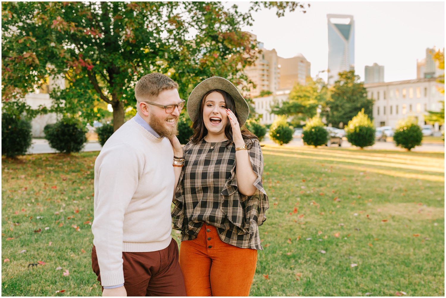 engaged couple laughs during CLT engagement portraits