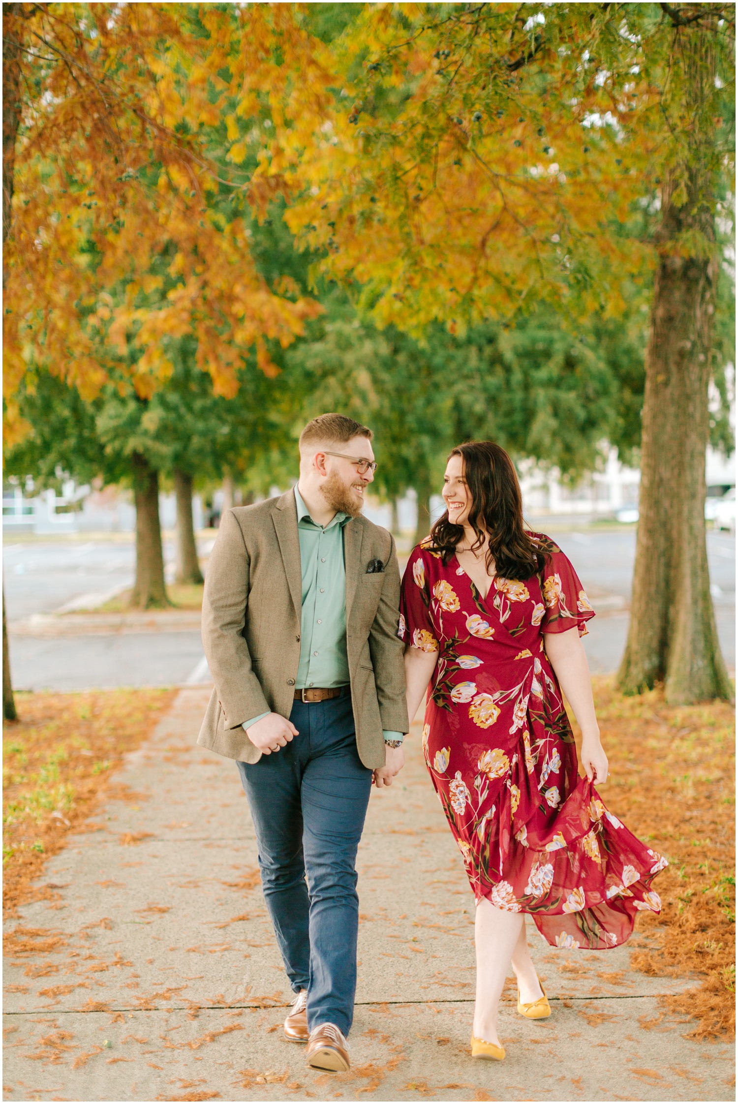 fall Charlotte NC engagement session with couple walking on sidewalk