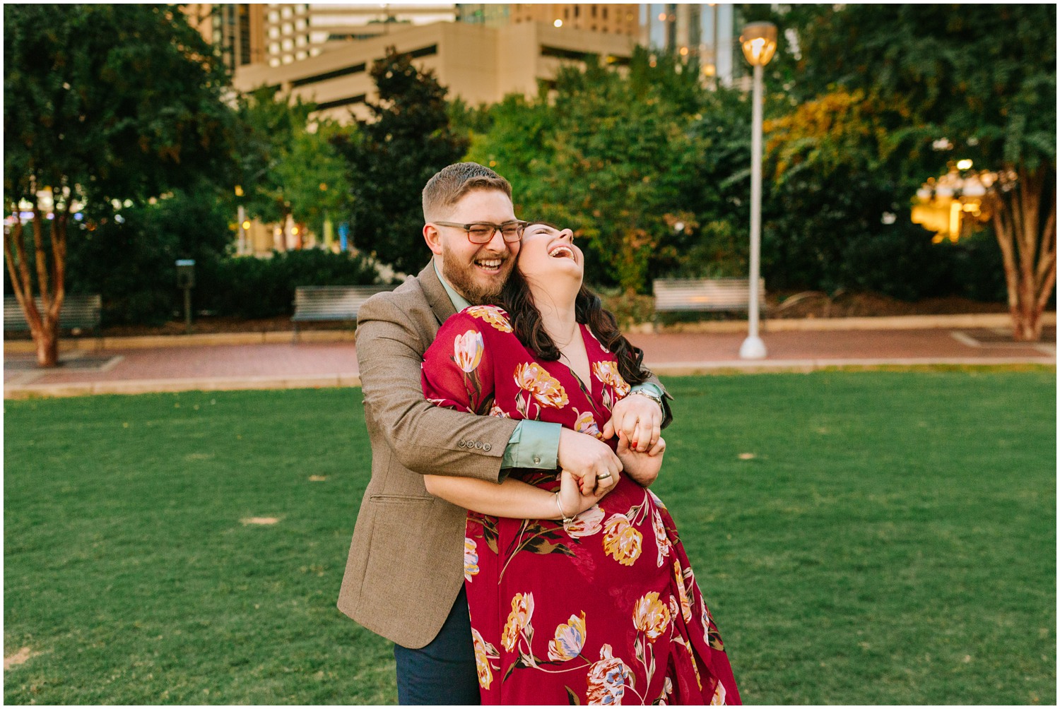 couple laughs during Charlotte Engagement Session at Marshall Park