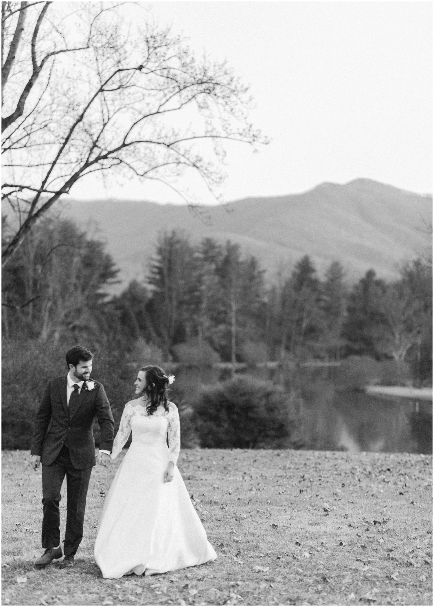 bride and groom walk away from Lake Eden in Black Mountain NC