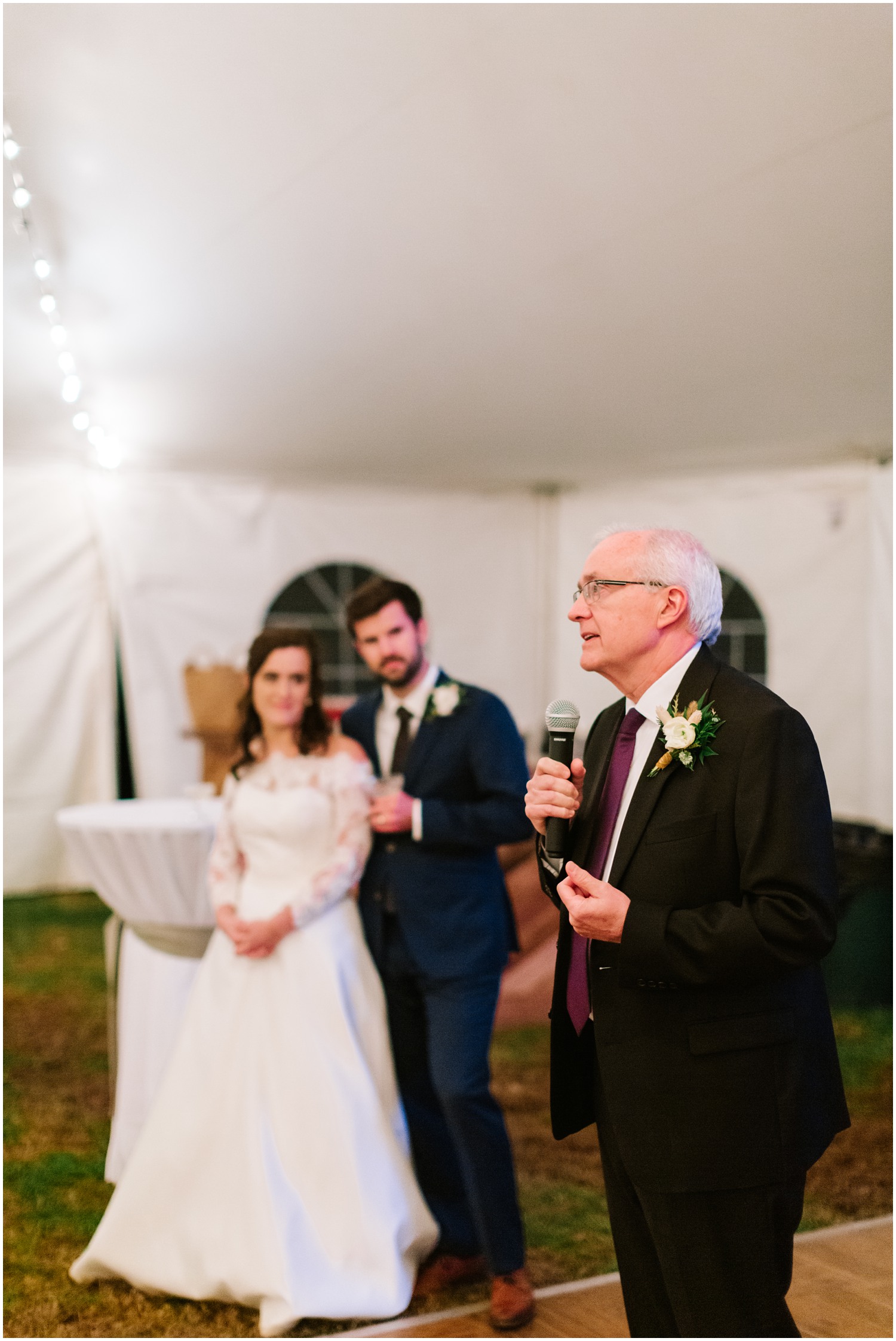 father gives wedding toast before reception at Lake Eden Events