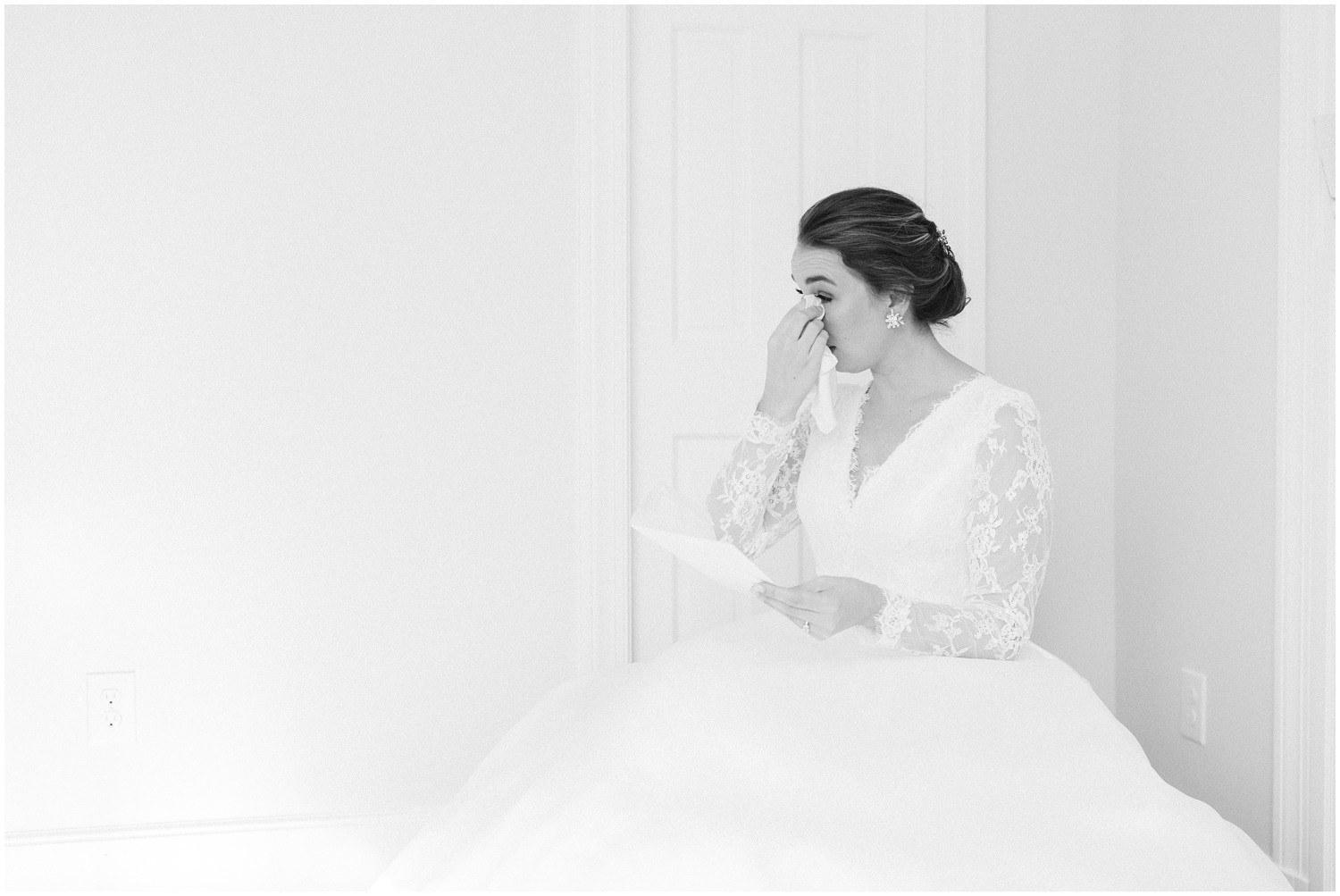 bride cries while reading letter from groom on wedding day